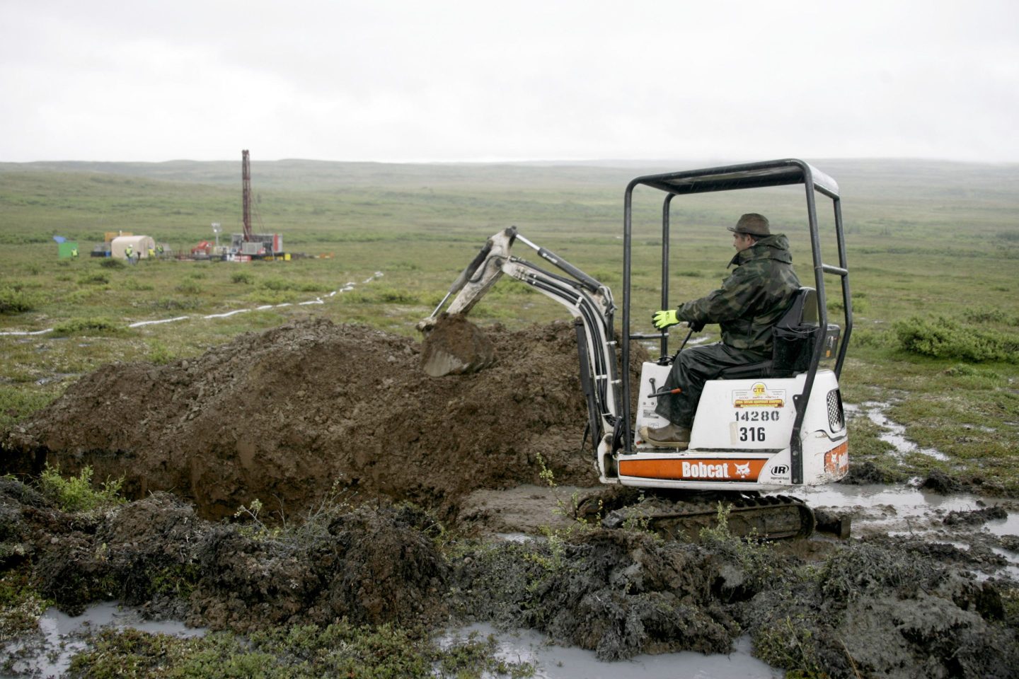 A worker with the Pebble Mine project digs in the Bristol Bay region of Alaska near the village of Iliamma, Alaska, July 13, 2007.