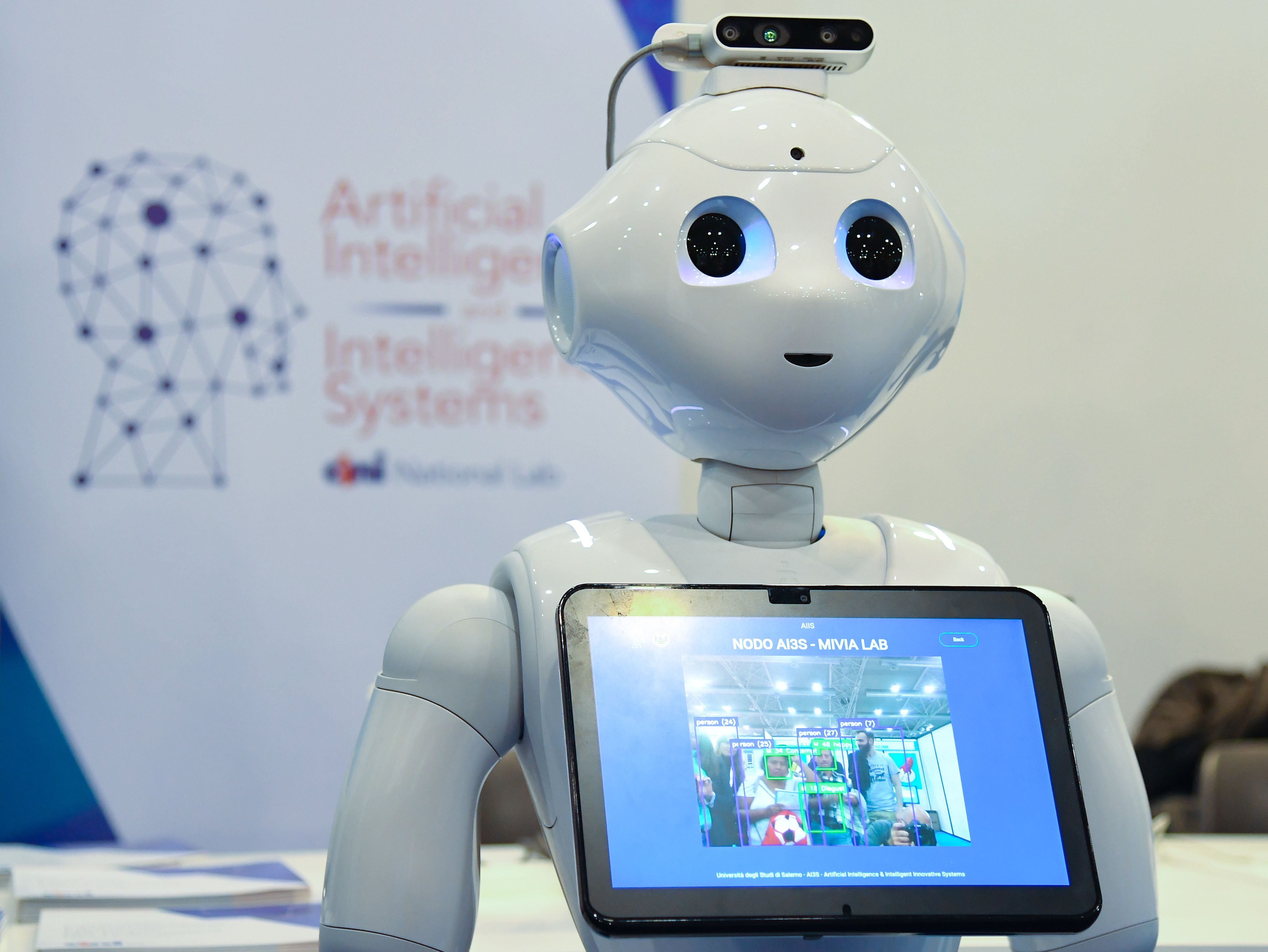 A robot holding a tablet