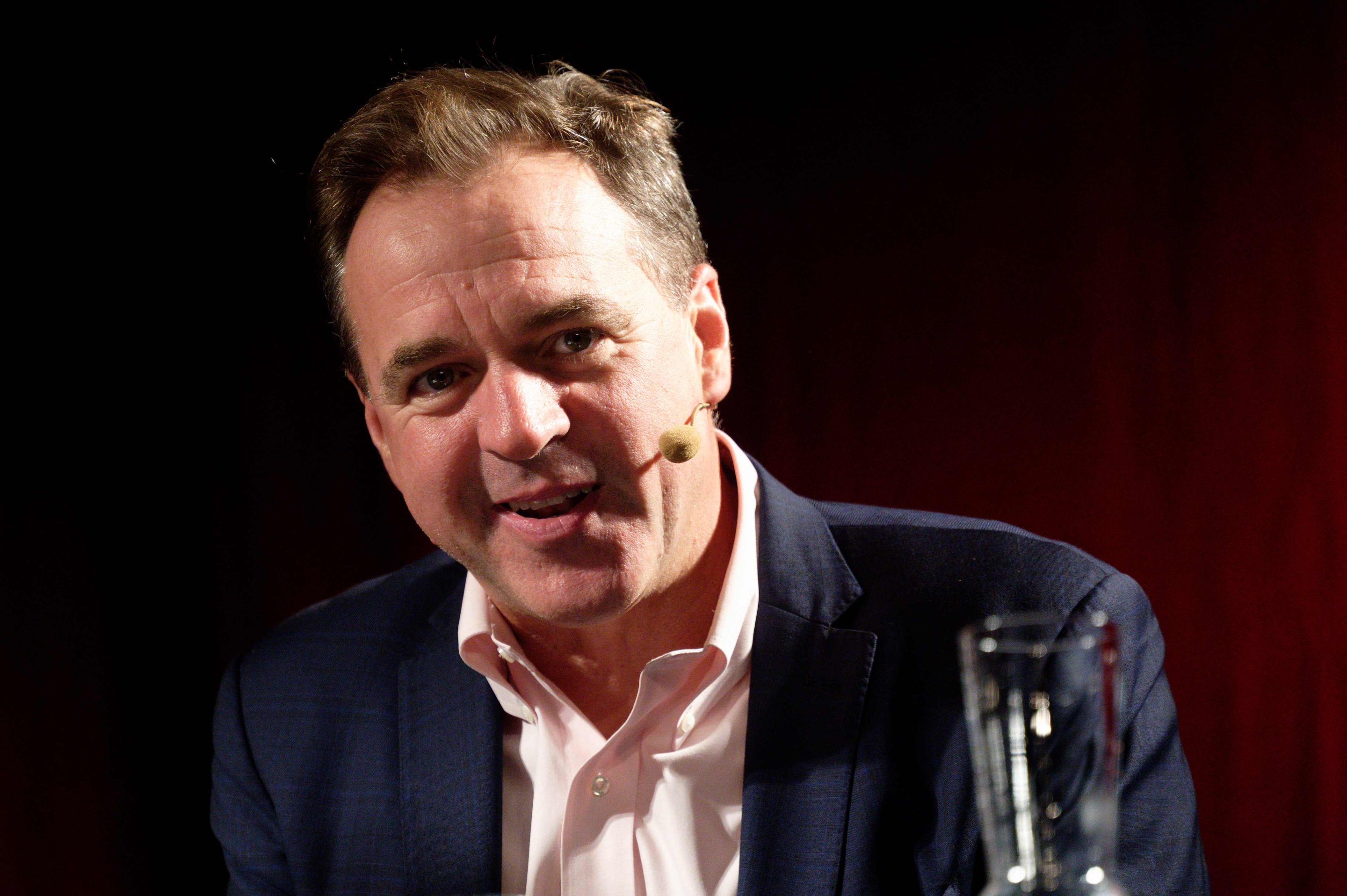Historian Niall Ferguson sits on the podium at one of the events "Doom - the Politics of Catastrophe." as part of the phil.cologne on the podium.