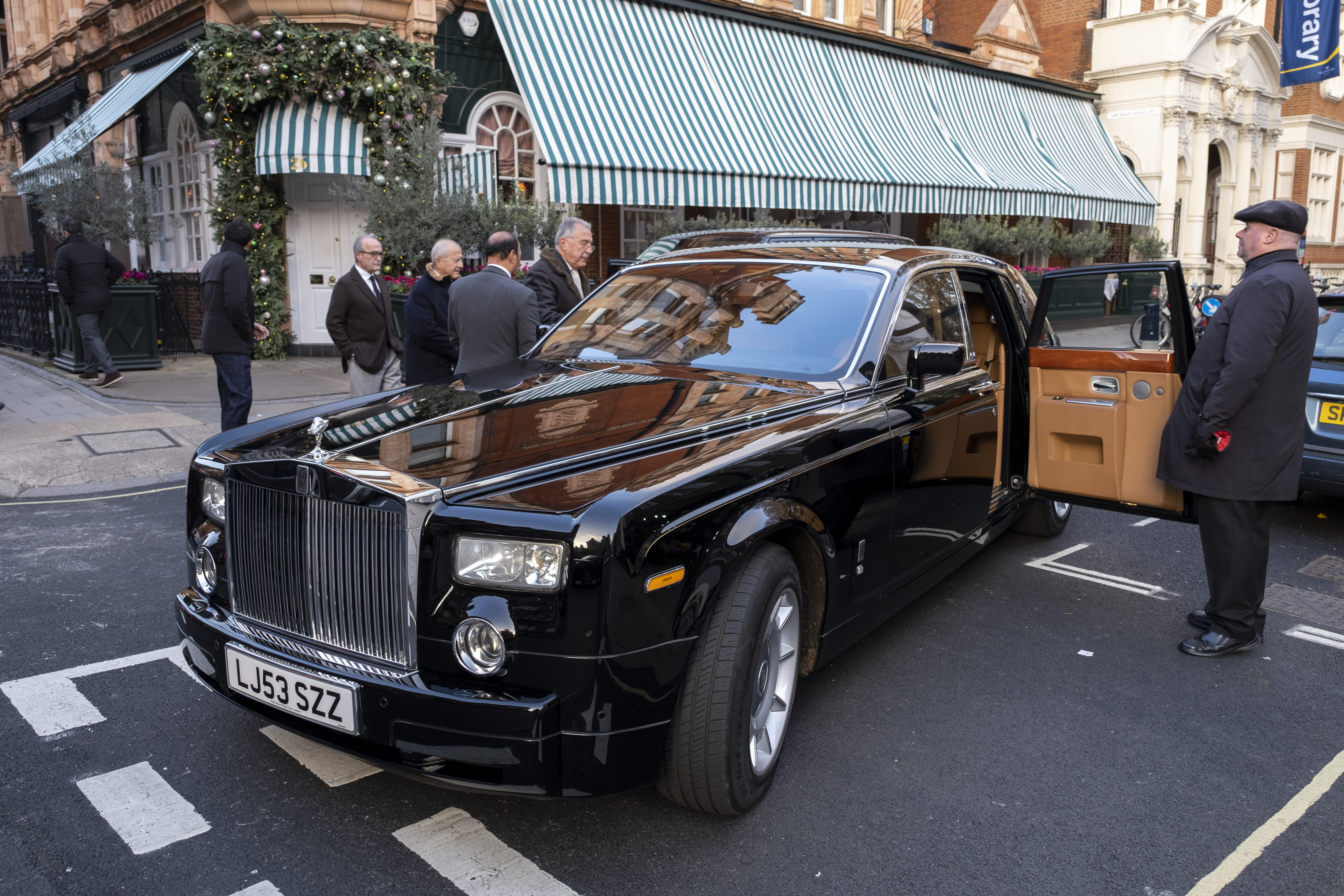 A Rolls Royce car on the street.