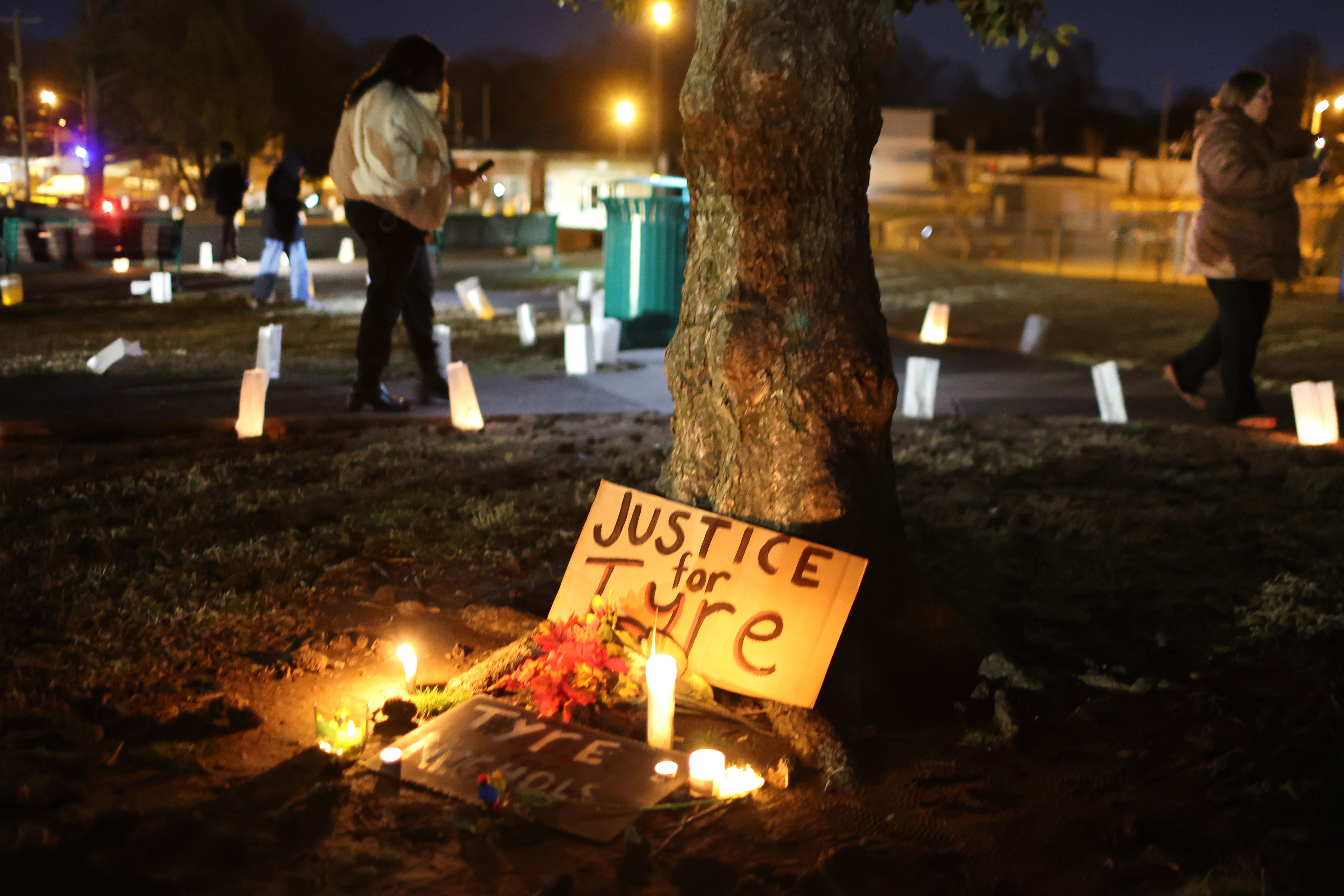 People attend a candlelight vigil in memory of Tyre Nichols.