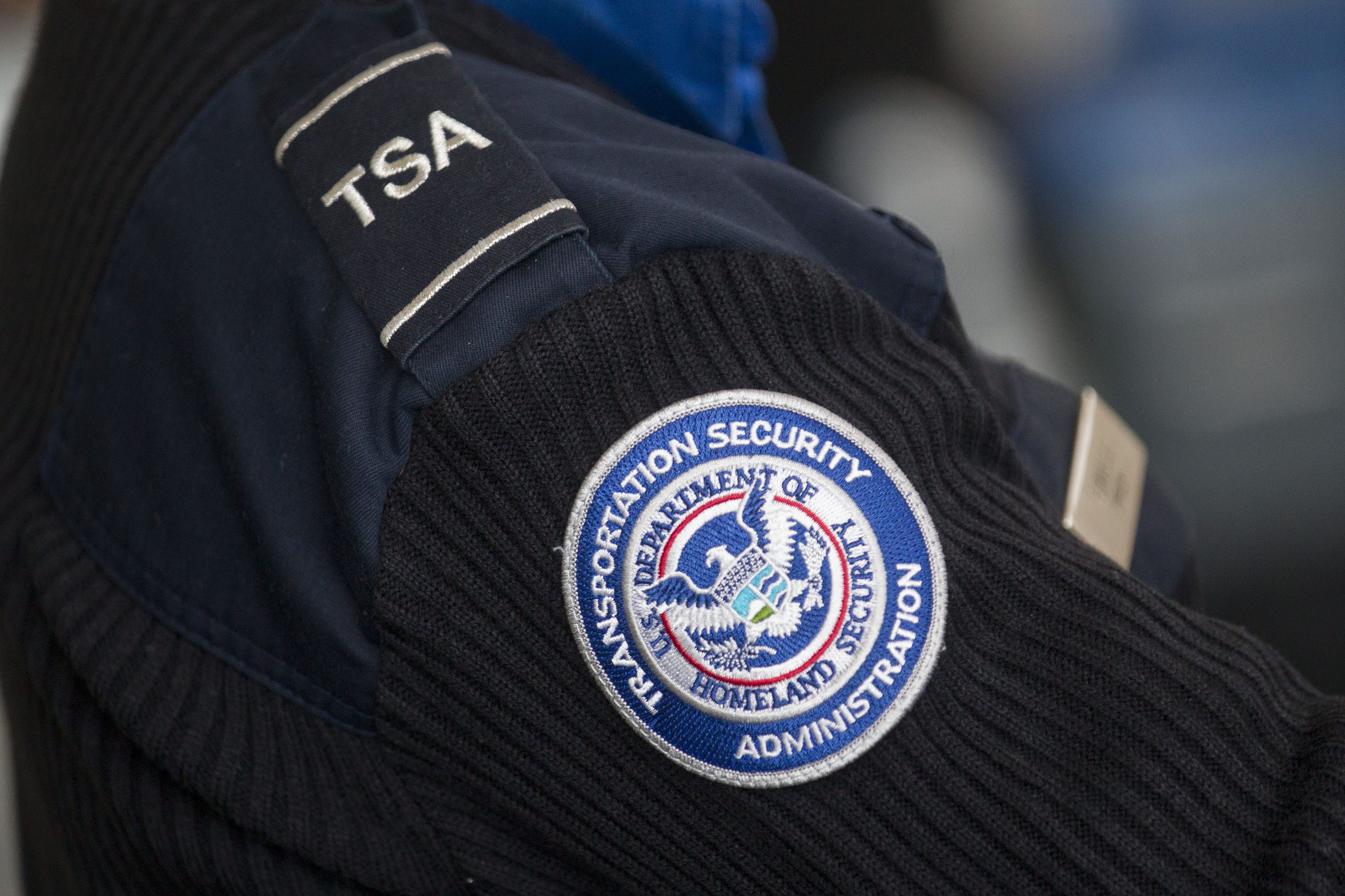 A Transportation Security Administration (TSA) officer works at a security checkpoint