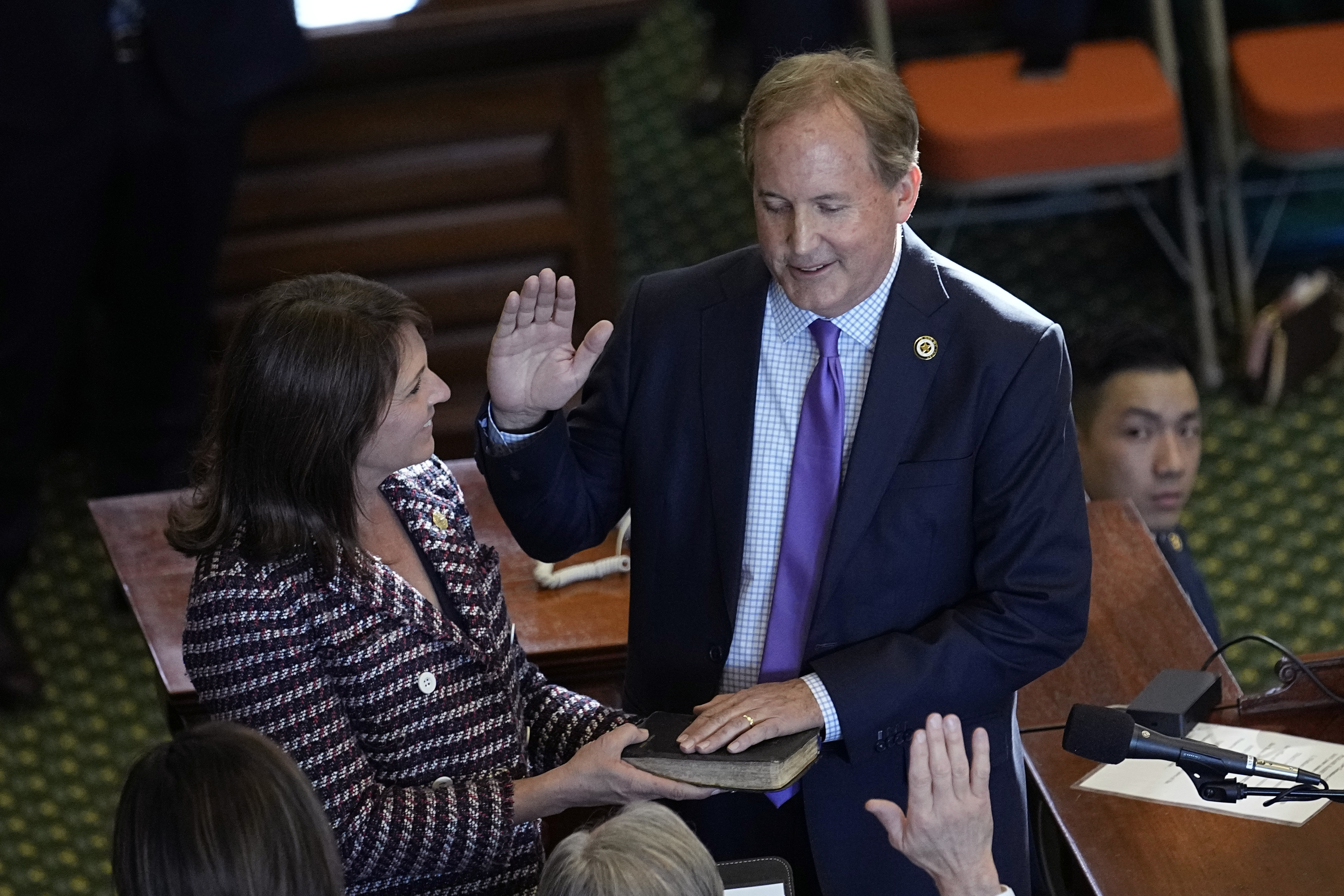 Texas Attorney General Ken Paxton, right, stands with his wife Texas state Sen. Angela Paxton, left, as he is sworn in for a third term in Austin, Texas, Tuesday, Jan. 10, 2023.