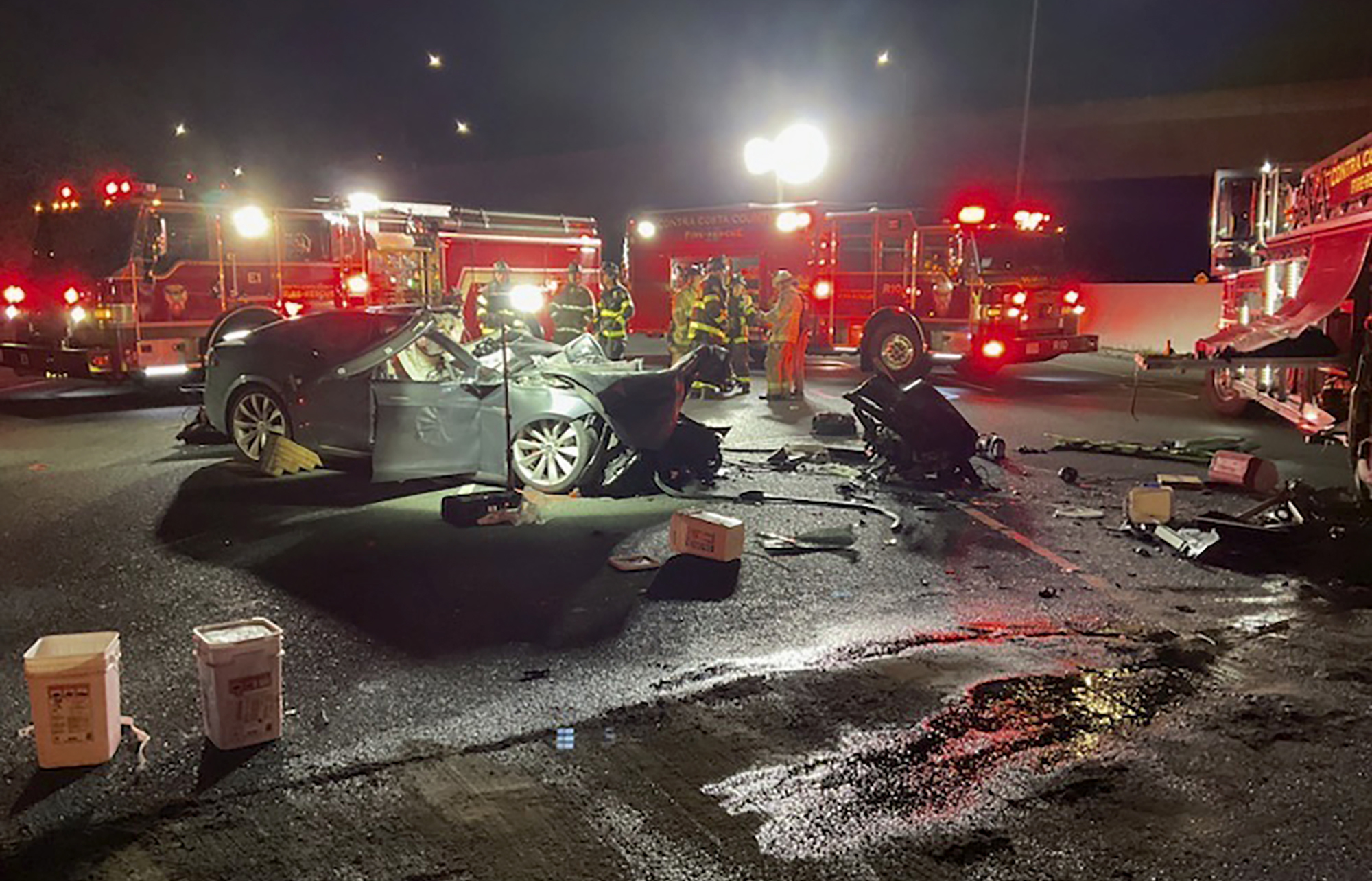 Firefighters work the scene of a fatal accident involving a Tesla and Contra Costa County fire truck early Saturday morning, Feb. 18, 2023, in Contra Costa, Calif.  
