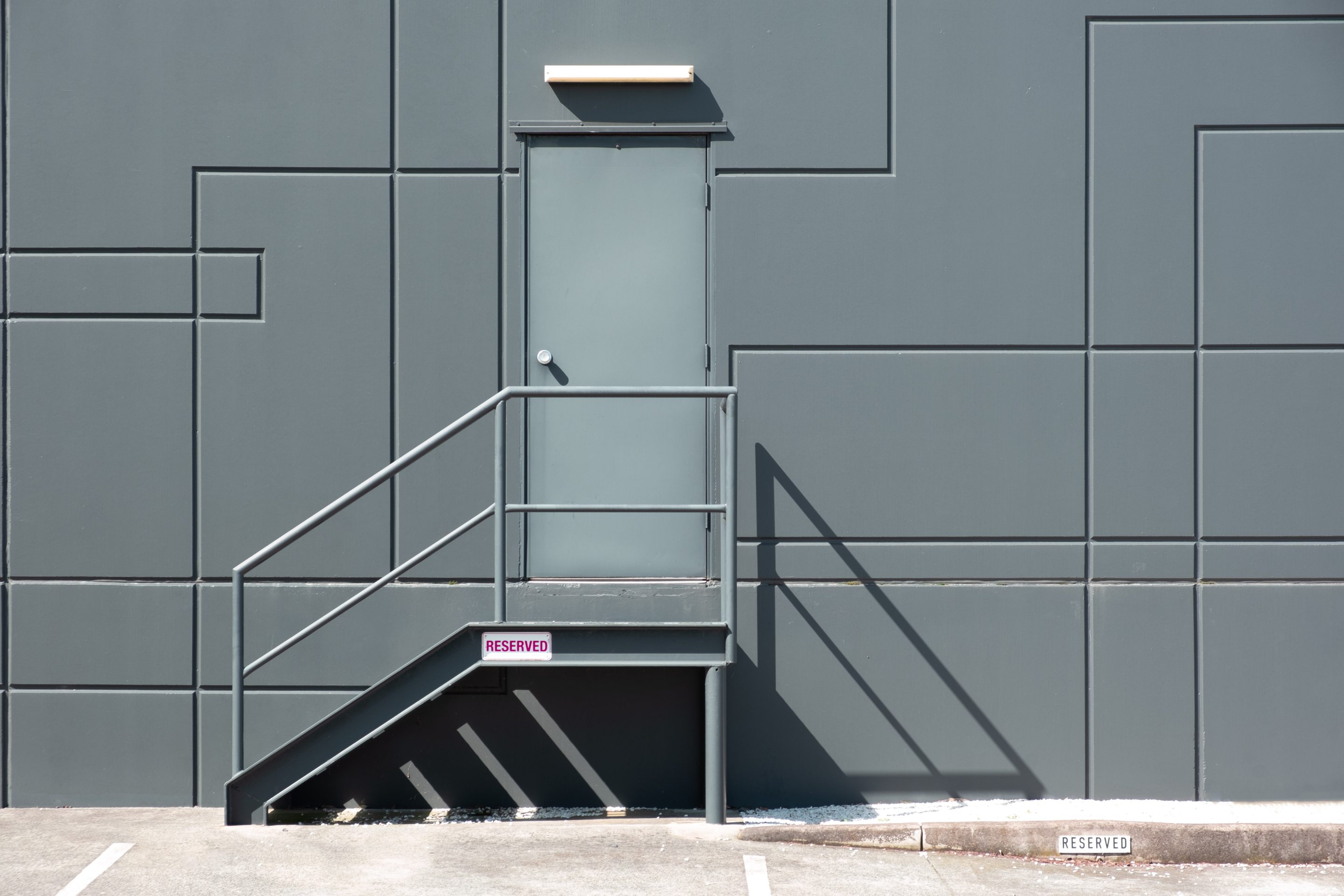 Rear Entrance Door With Metal Stairs Into Industrial Building - Minimal Clean Geometric Shapes