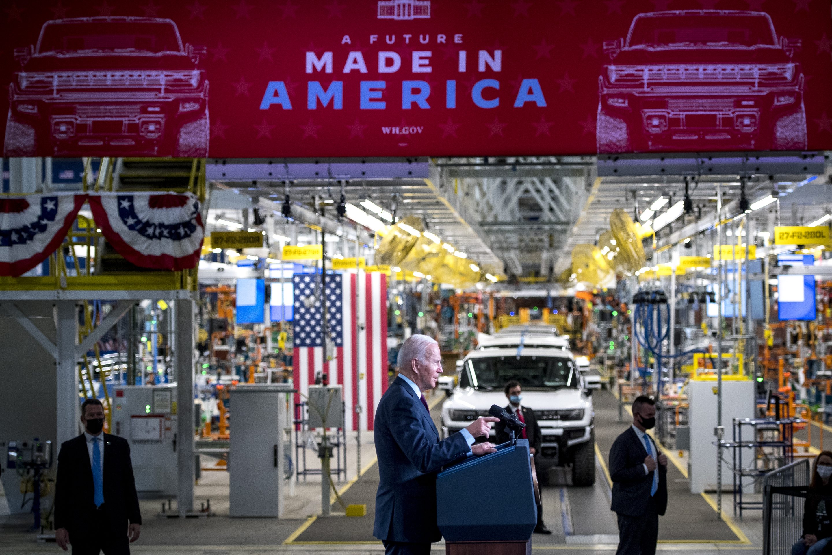 A picture of President Joe Biden at an electric vehicle assembly factory.
