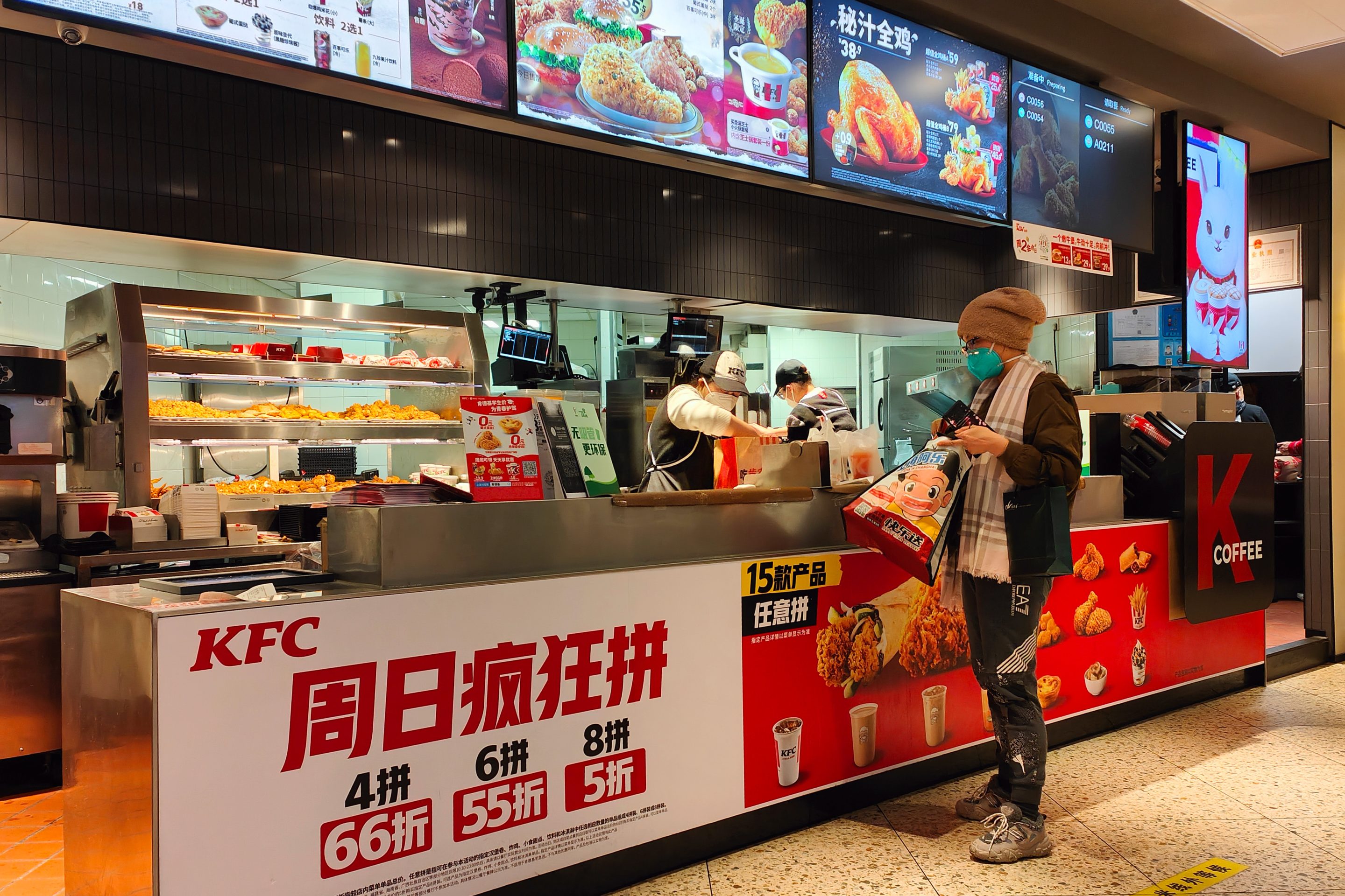 A customer picks up an order at a KFC restaurant in Shanghai, on Dec. 19, 2022.