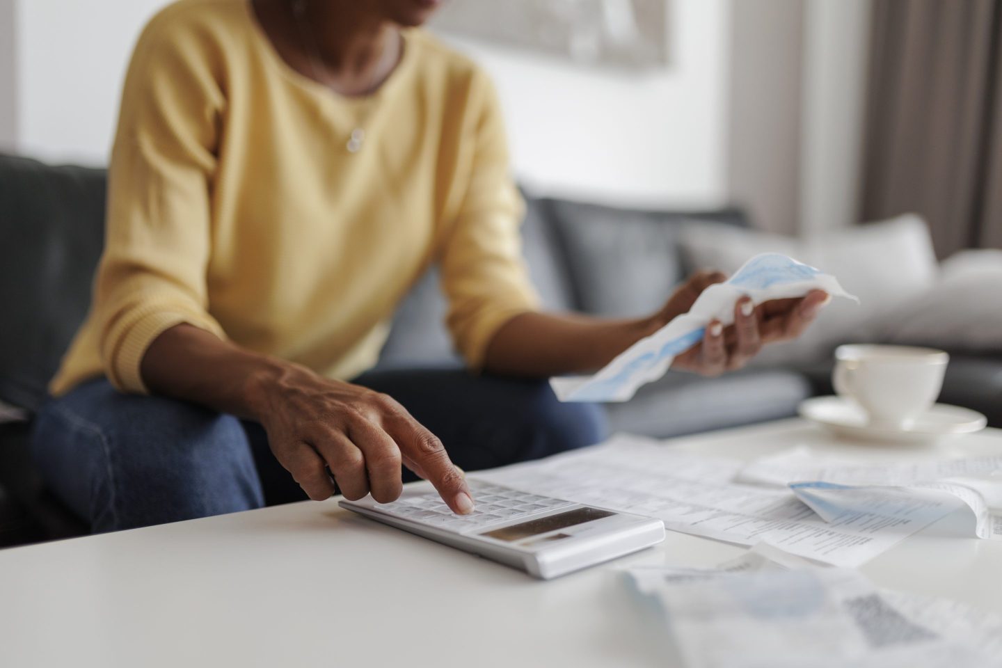 Close-up of a woman checking her energy bills at home