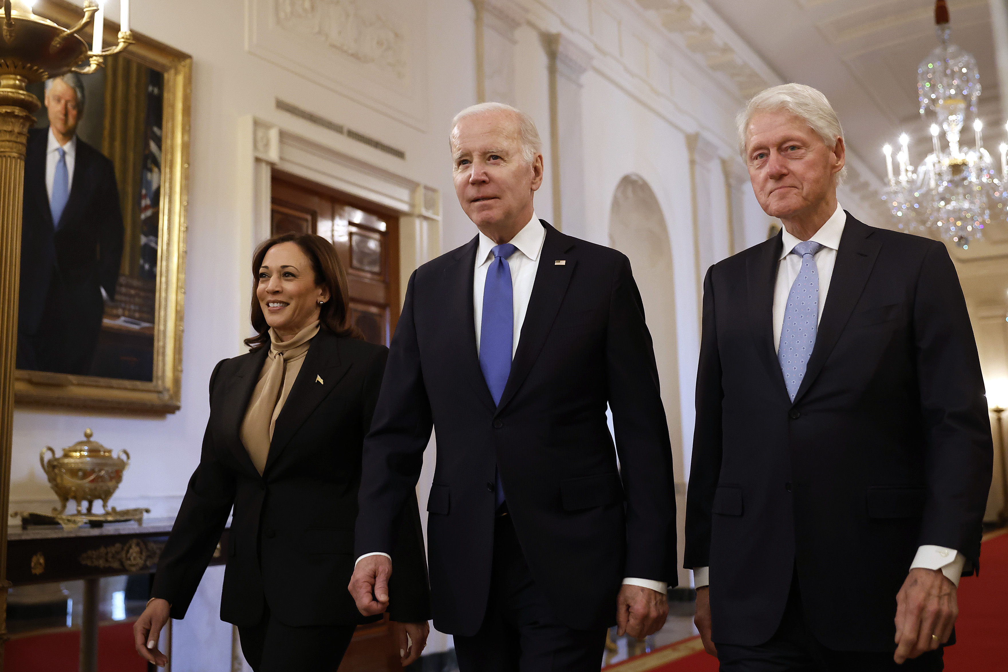Vice President Kamala Harris, President Joe Biden and former President Bill Clinton walk into the East Room for an event to mark the 30th anniversary of the Family and Medical Leave Act at the White House on Feb. 2 in Washington, D.C.