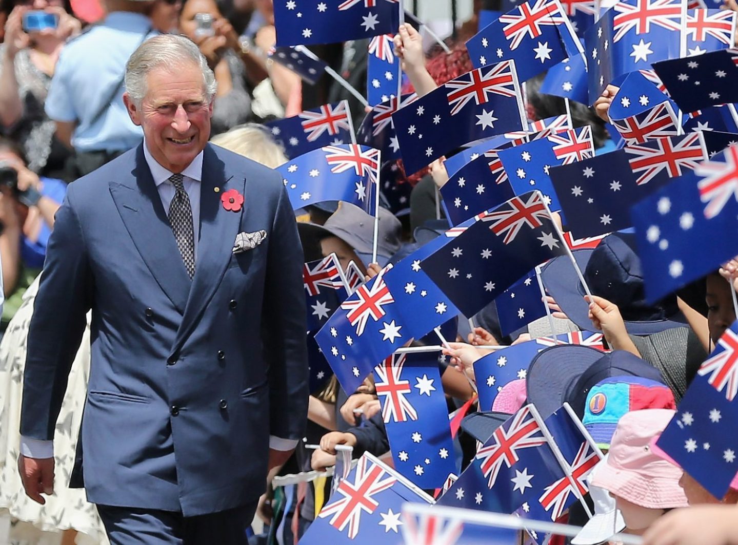 Schoolchildren wave Australian flags as Prince Charles, Prince of Wales visits Kilkenny Primary School on November 7, 2012 in Adelaide, Australia.