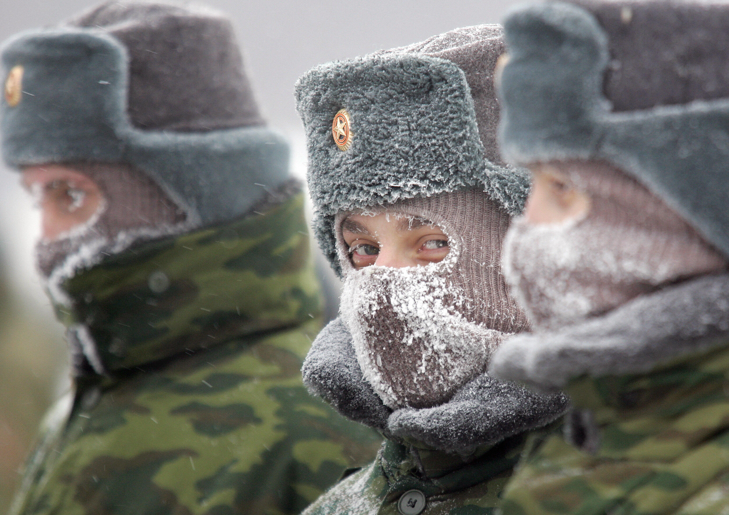 Russian soldiers wear face-masks standing at the parade-ground at their military unit outside Moscow, 20 January 2006.