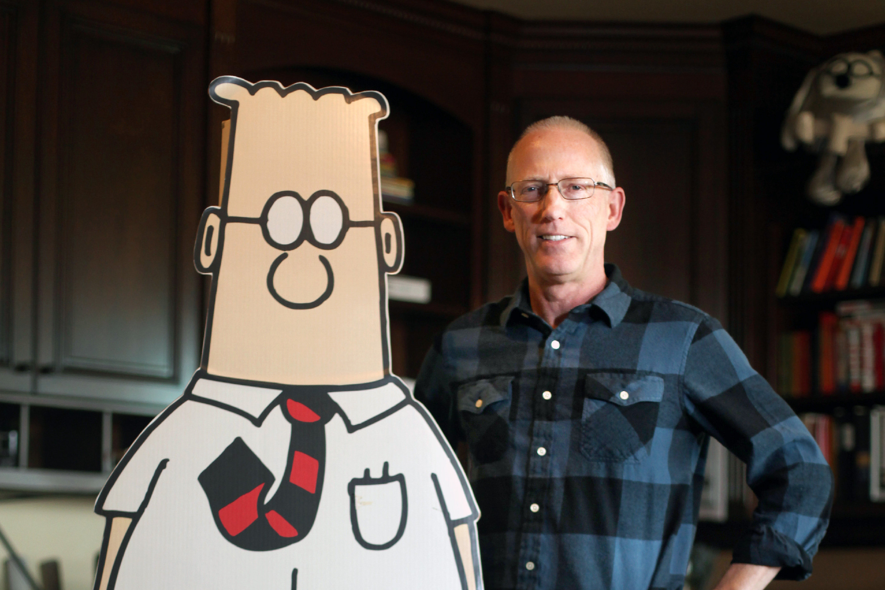 Scott Adams, cartoonist and author and creator of "Dilbert", poses for a portrait with a life-sized Dilbert cutout in his home office on Monday, January 6, 2014 in Pleasanton, Calif.