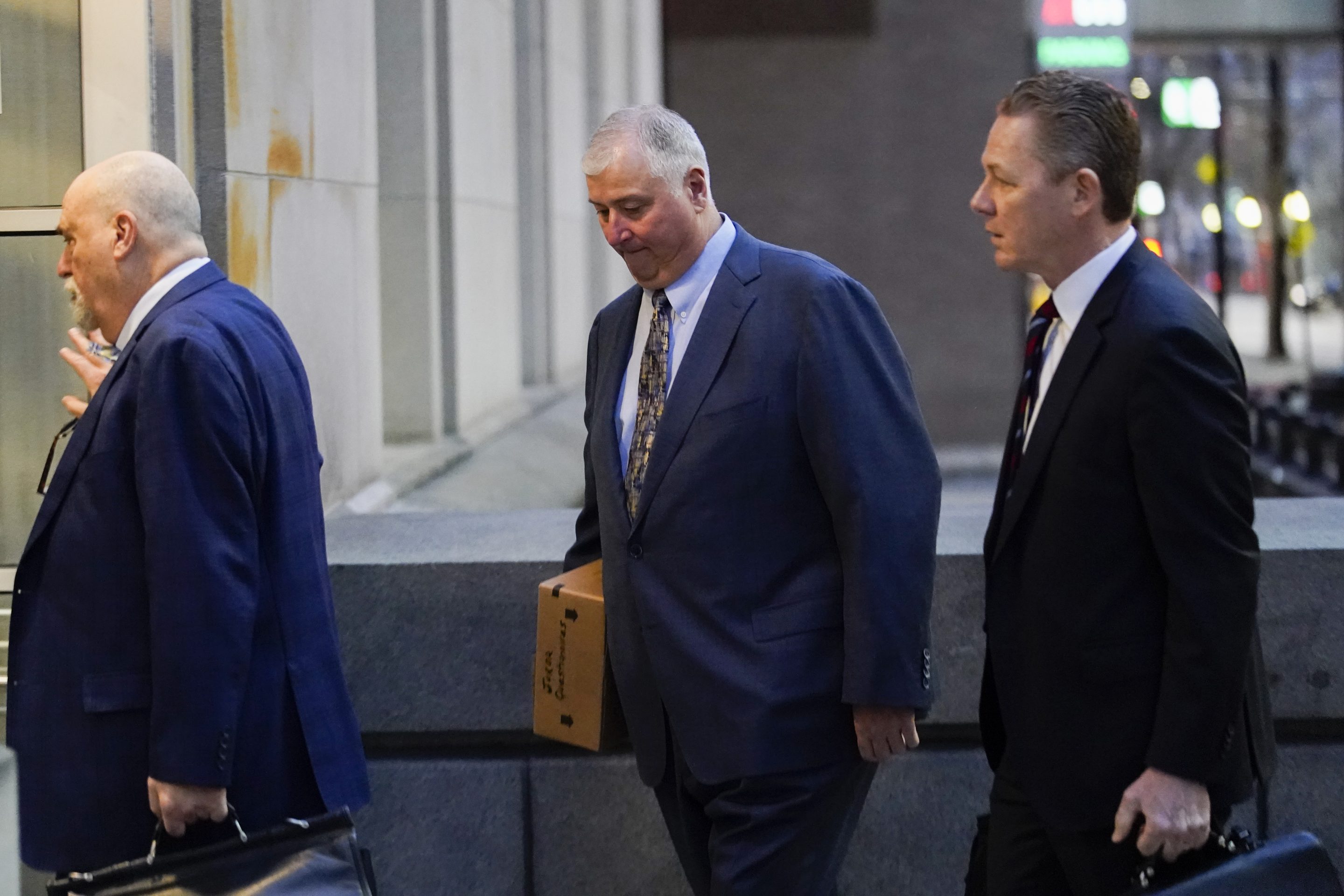 Former Ohio House Speaker Larry Householder, center, walks into Potter Stewart U.S. Courthouse with his attorneys, Mark Marein, left, and Steven Bradley, right, before jury selection in his federal trial, Jan. 20, 2023, in Cincinnati, Ohio.