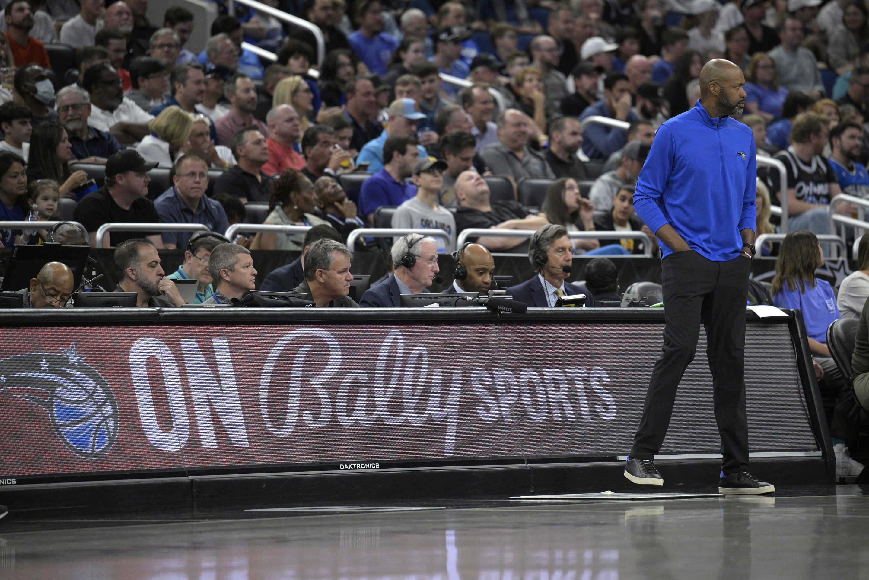 Orlando Magic coach Jamahl Mosley, right, stands next to an advertisement for Bally Sports during the first half of the team's NBA basketball game against the Detroit Pistons, Feb. 23, 2023, in Orlando, Fla. 