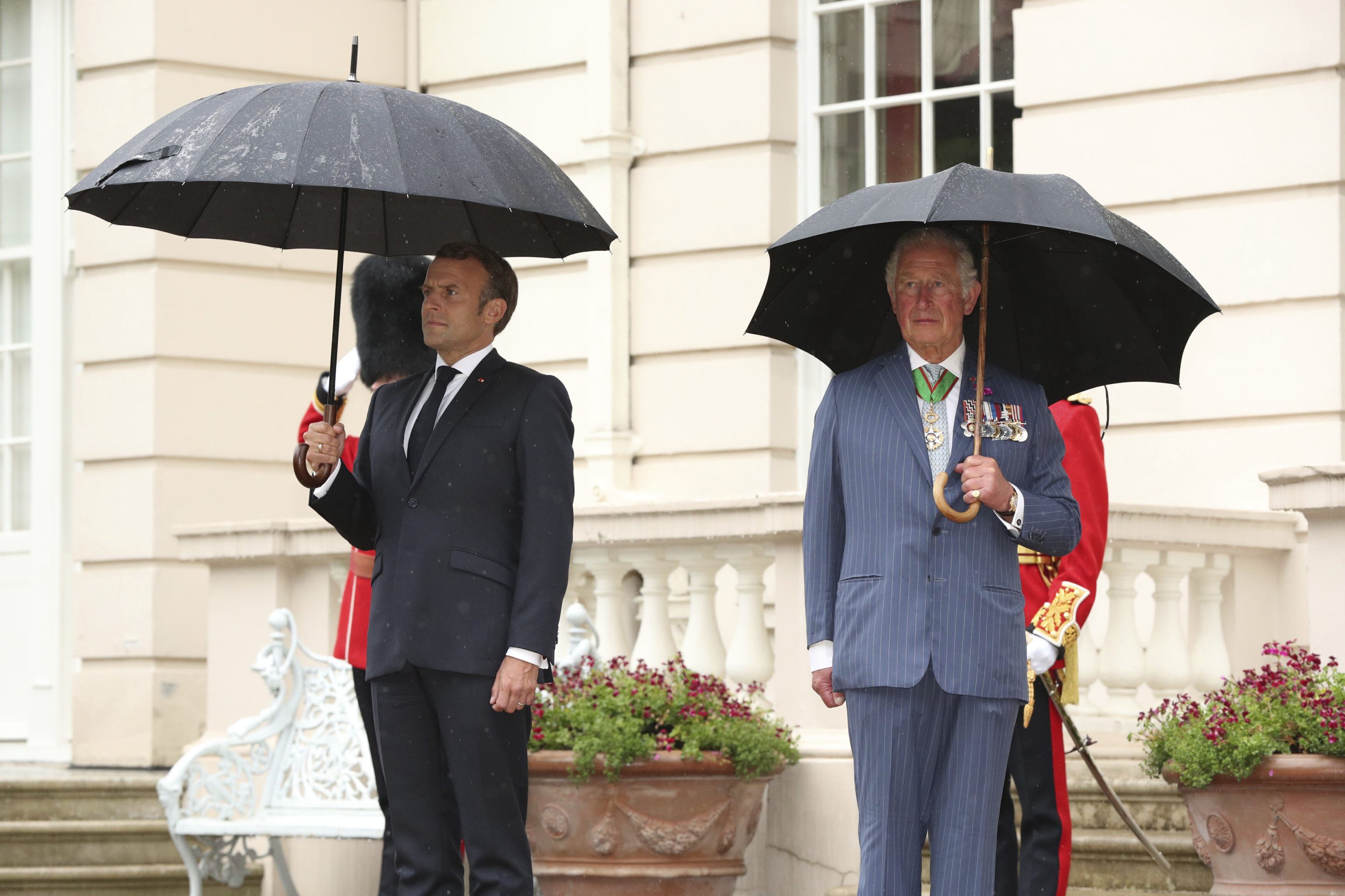 Britain's Prince Charles welcomes French president Emmanuel Macron, left, to Clarence House in London, on June 18, 2020.