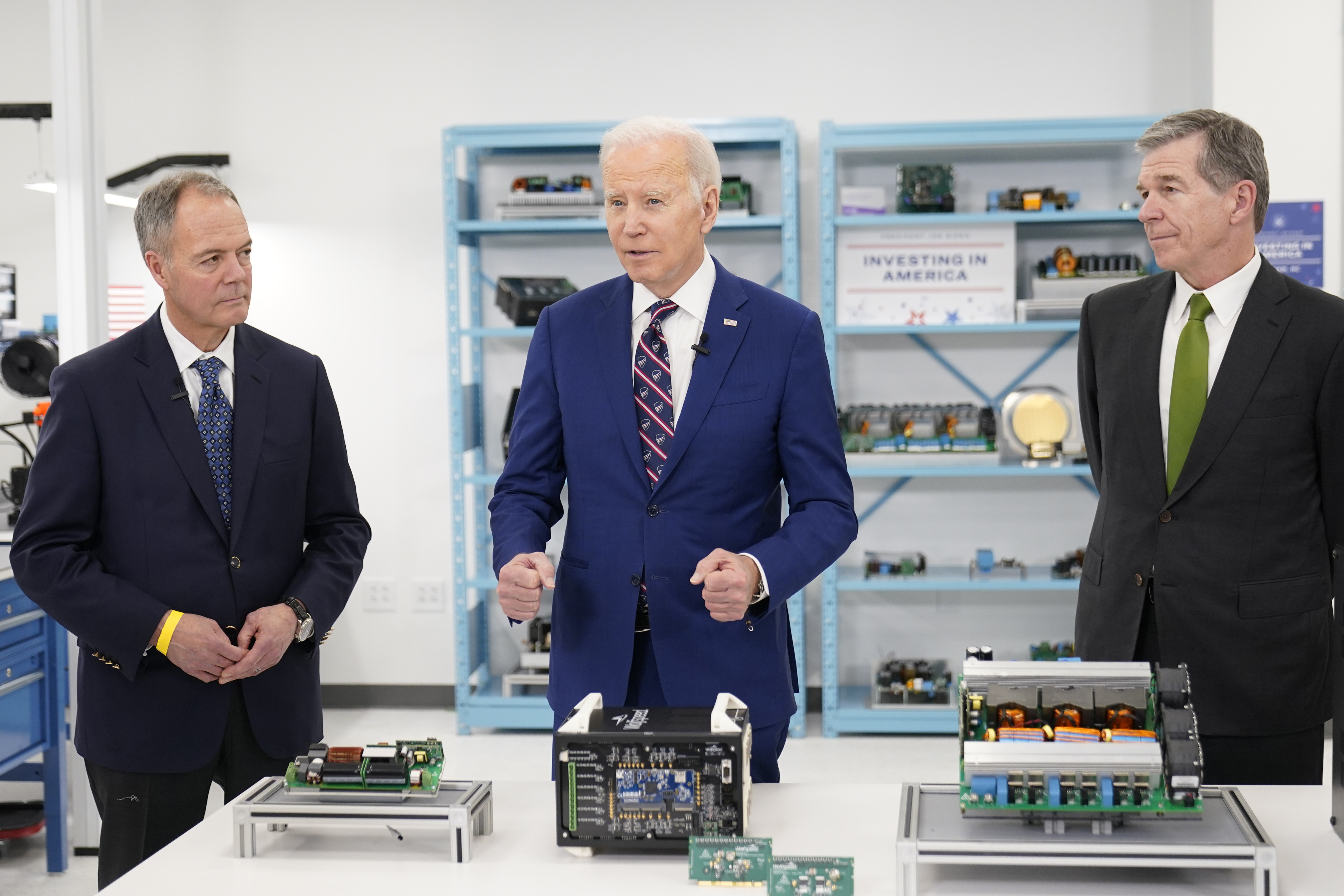 President Joe Biden tours semiconductor manufacturer Wolfspeed Inc., in Durham, N.C., Tuesday, March 28, 2023, with CEO Gregg Lowe and North Carolina Gov. Roy Cooper, right. (AP Photo/Carolyn Kaster)