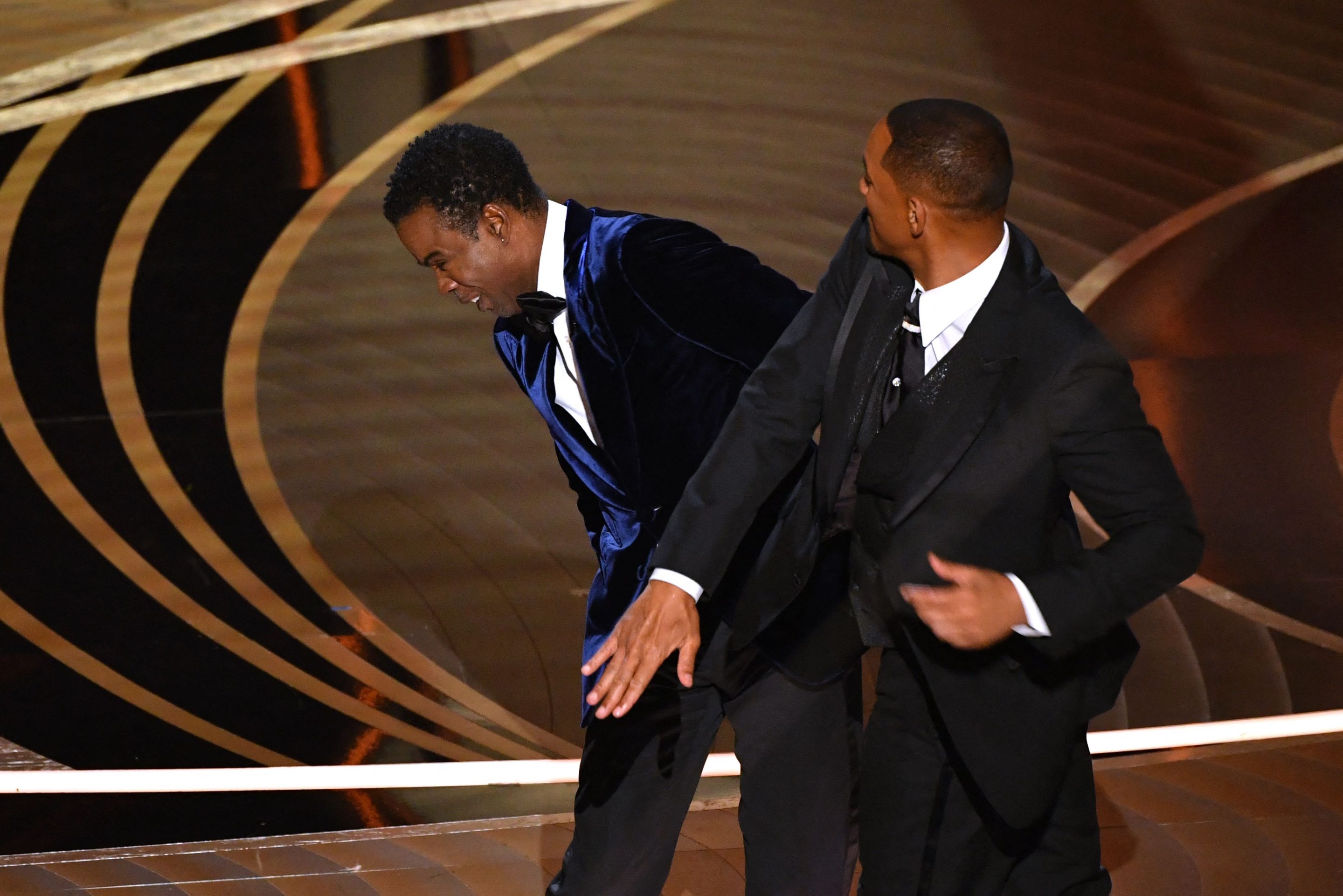 Actor Will Smith (R) slaps Chris Rock onstage during the 94th Oscars.