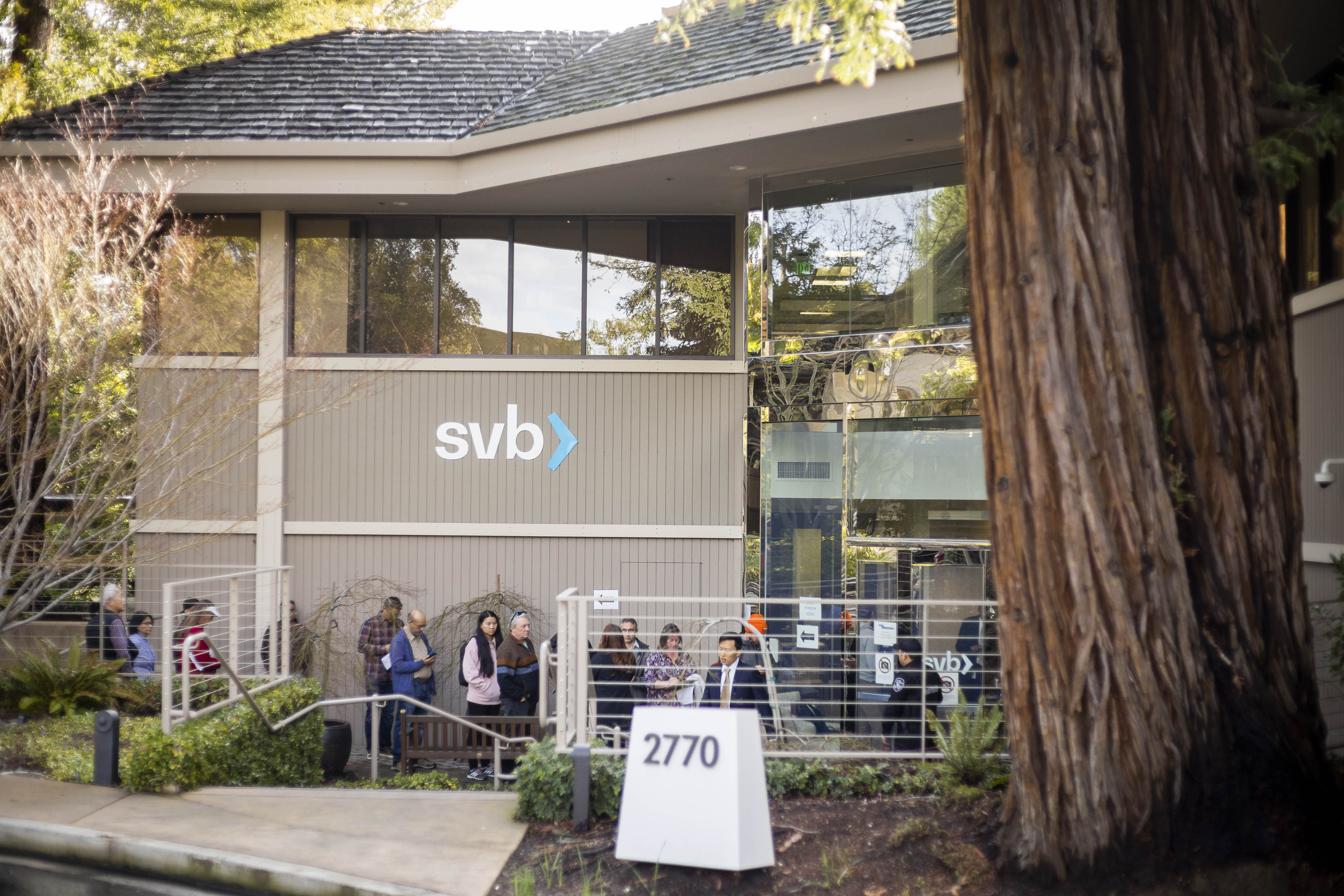 People wait for service outside Silicon Valley Bank in Menlo Park, Calif.