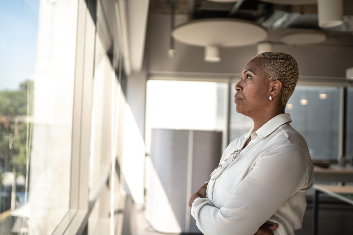 Serious businesswoman looking through the window