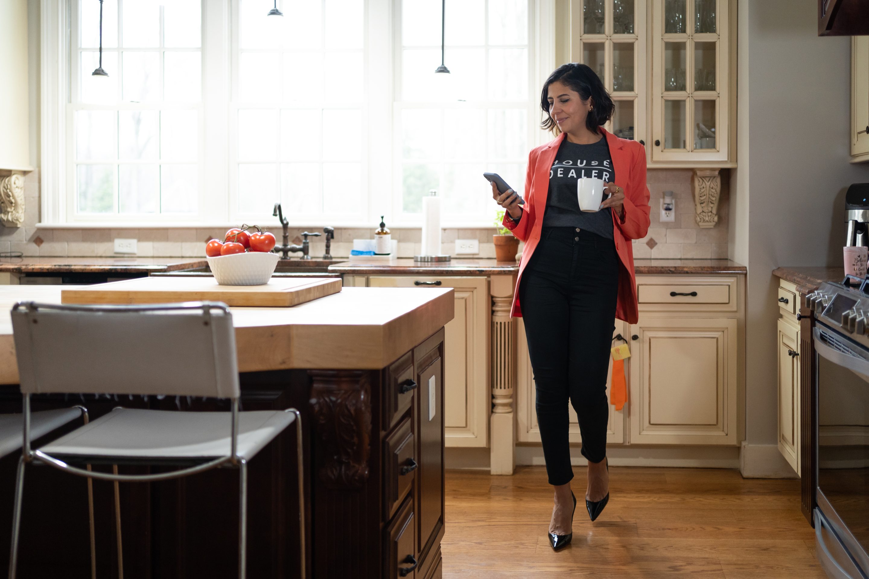 professional woman drinking coffee in her kitchen