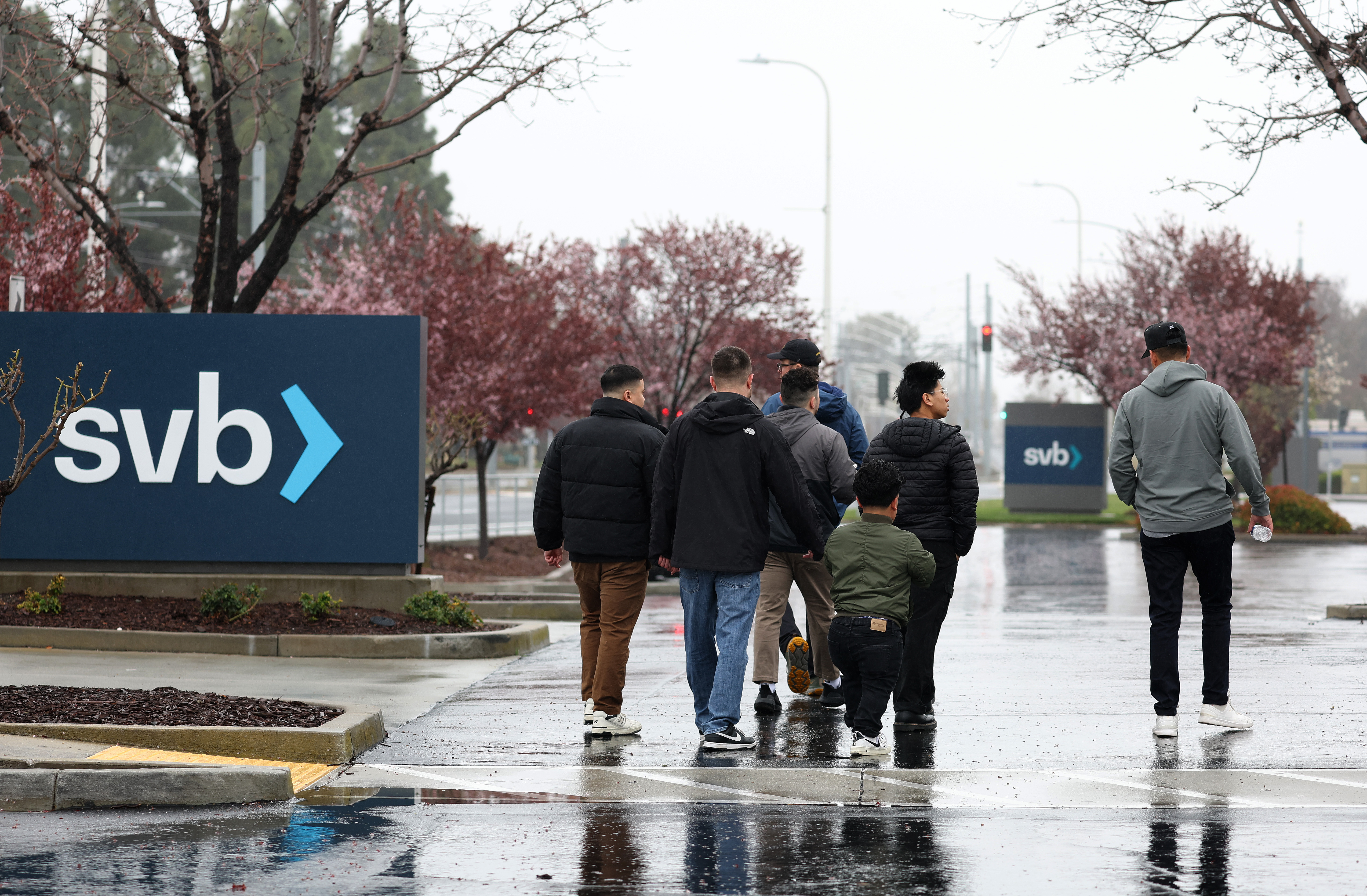 People walk through the parking lot at the Silicon Valley Bank (SVB) headquarters on March 10, 2023 in Santa Clara, California.