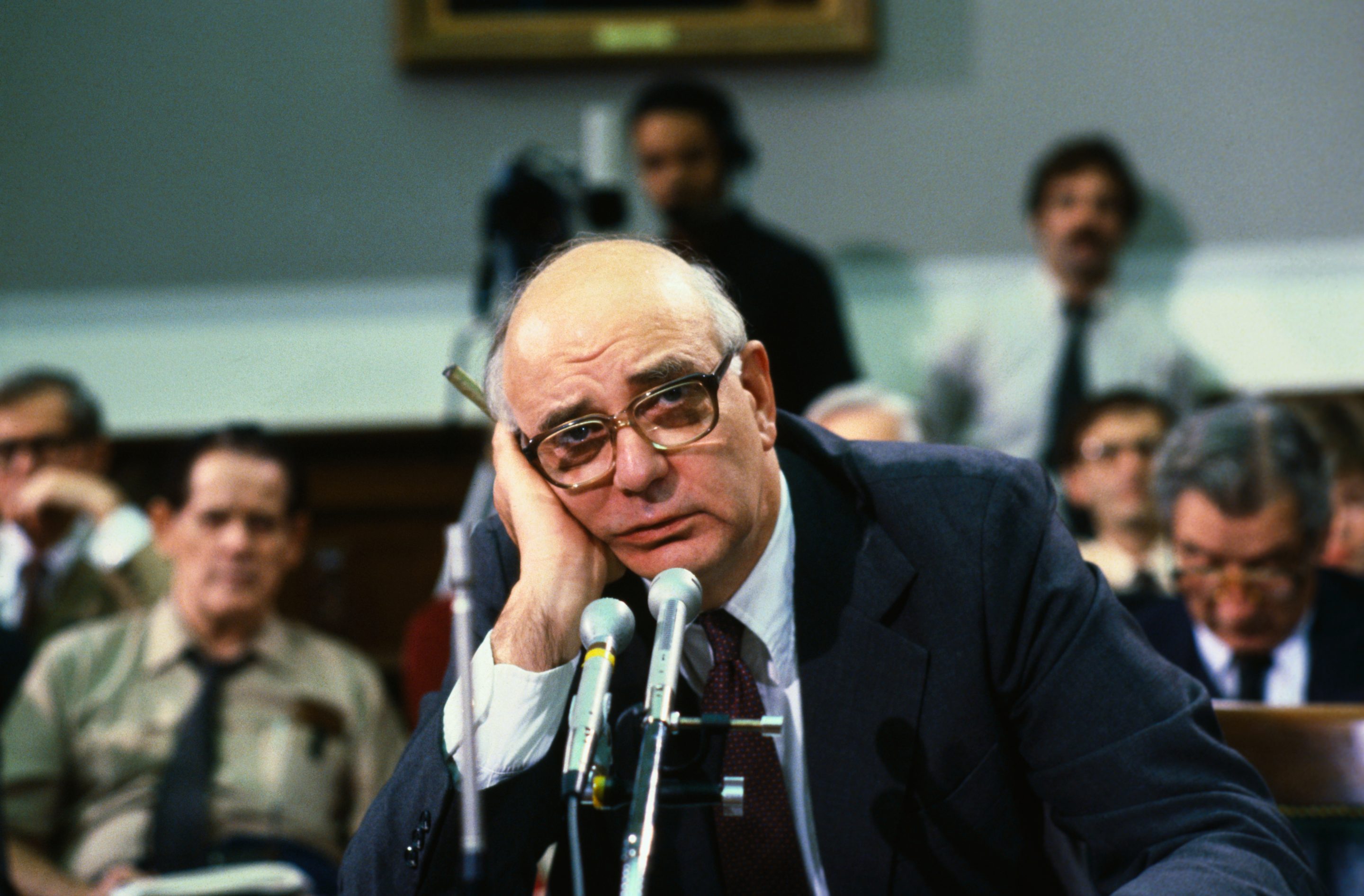 Chairman of the Federal Reserve Board, Paul Volcker, holding his head with his hand during meeting in Washington, DC.
