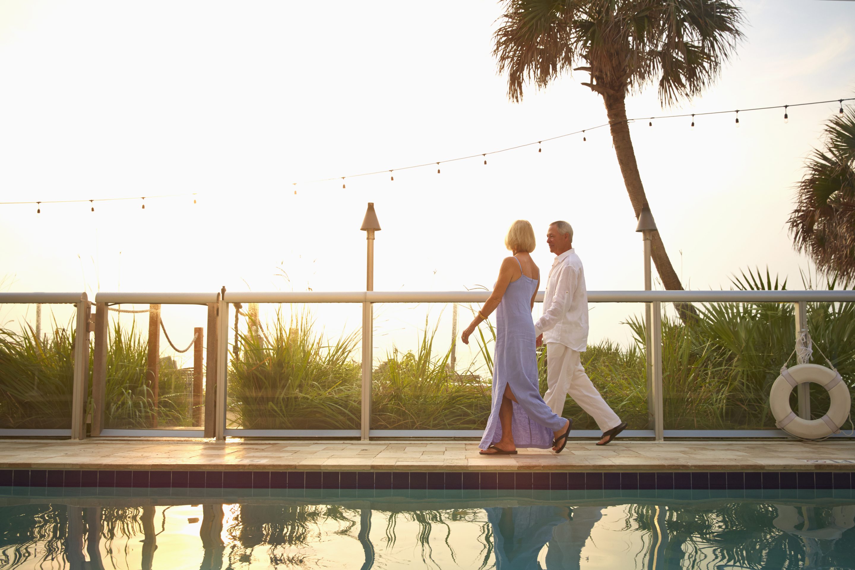 couple walking on the beach at sunset