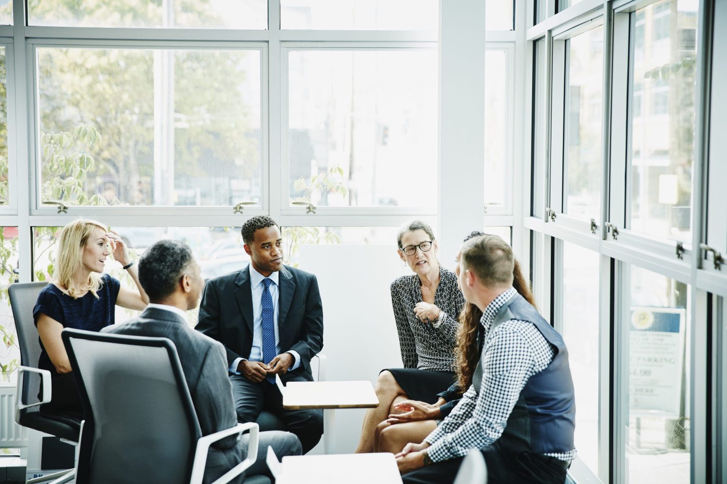 A group of office workers have a meeting in a conference room.