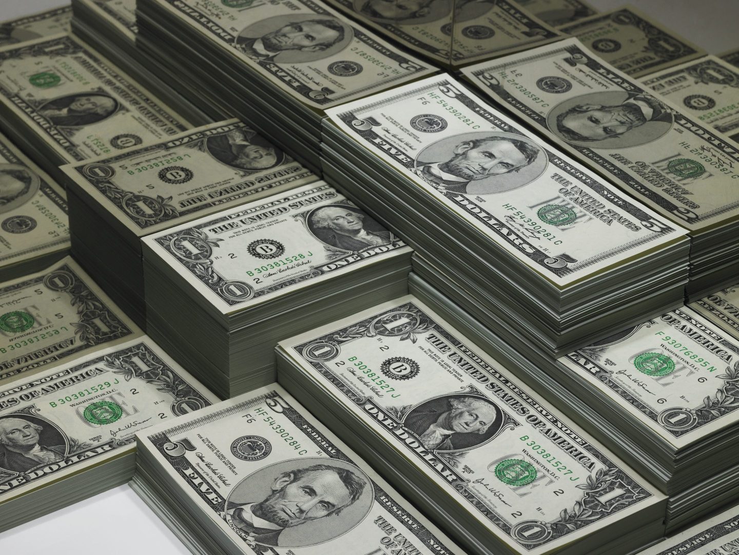 Piles of U.S. dollars are pictured.