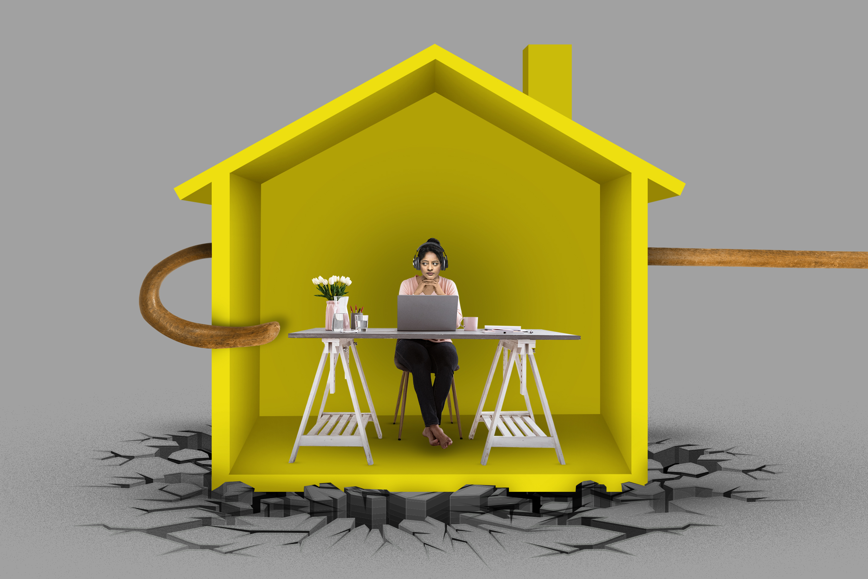 Photo illustration of a woman sitting at her desk inside a yellow house with a cane hooked around it ready to pull it away and the ground cracked heavily beneath.