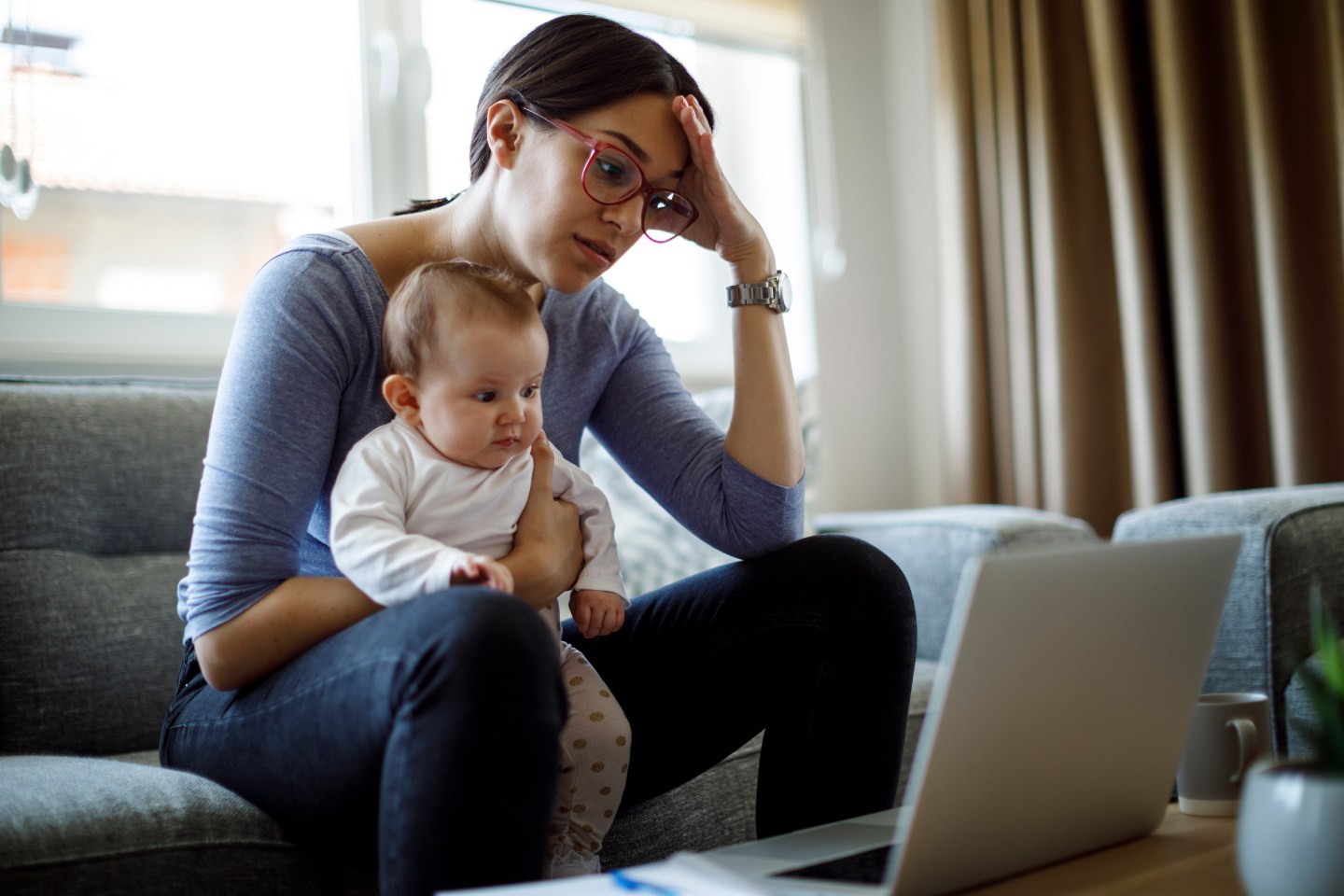 Tired young mother working from home.