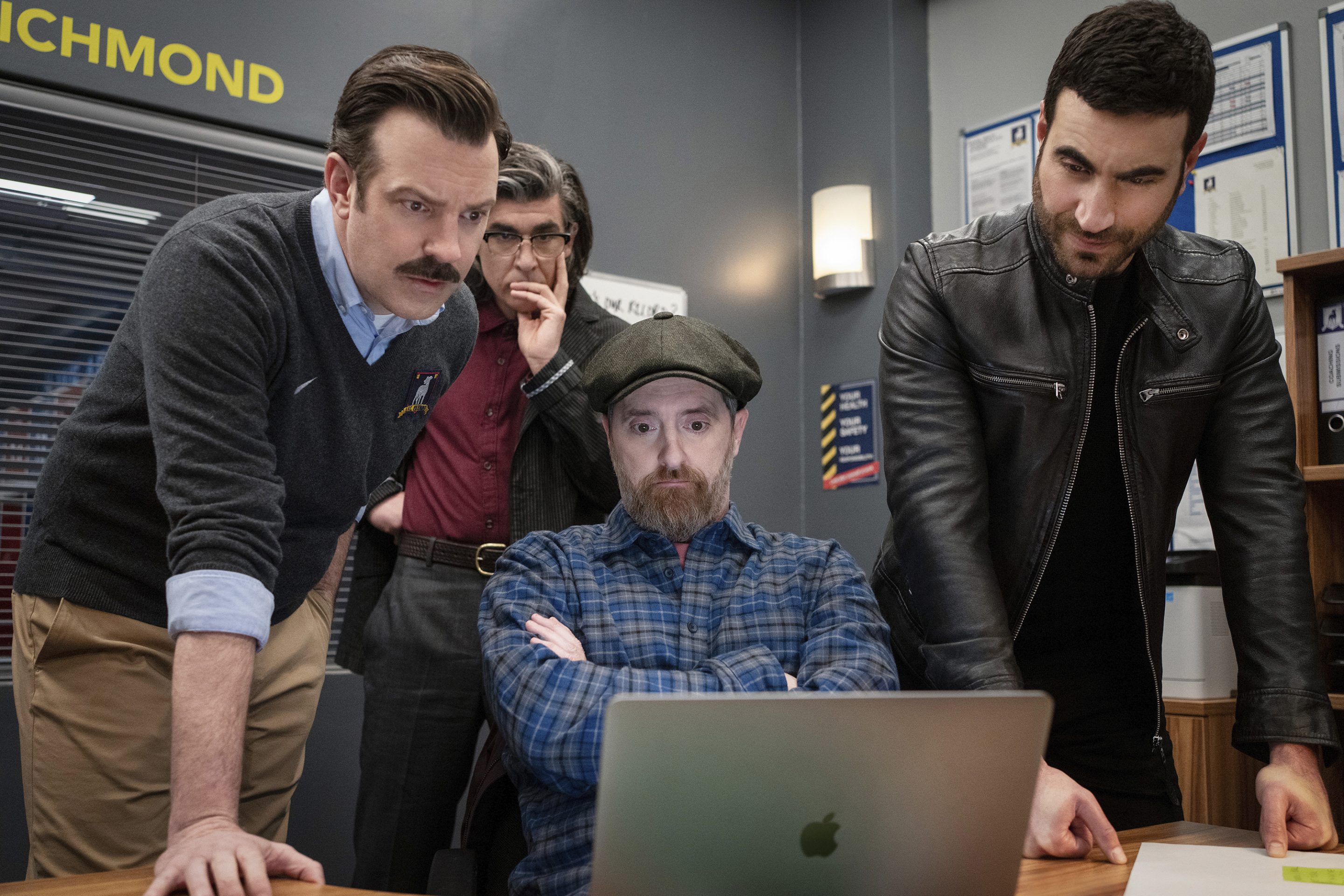 This image released by Apple TV+ shows Jason Sudeikis, from left, James Lance, Brendan Hunt and Brett Goldstein in a scene from "Ted Lasso."