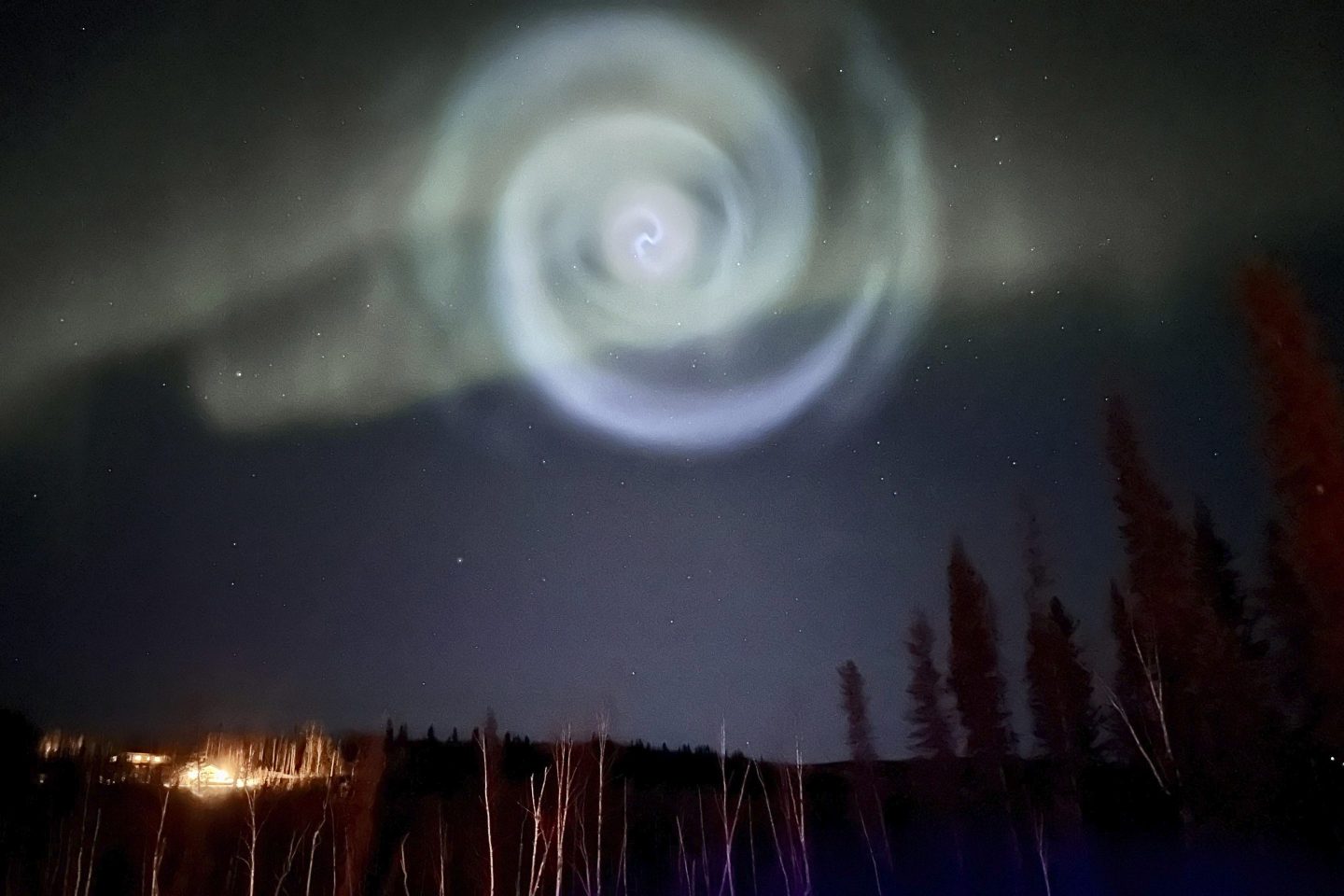 SpaceX launch leaves mysterious blue spiral amid northern lights in Alaska night sky