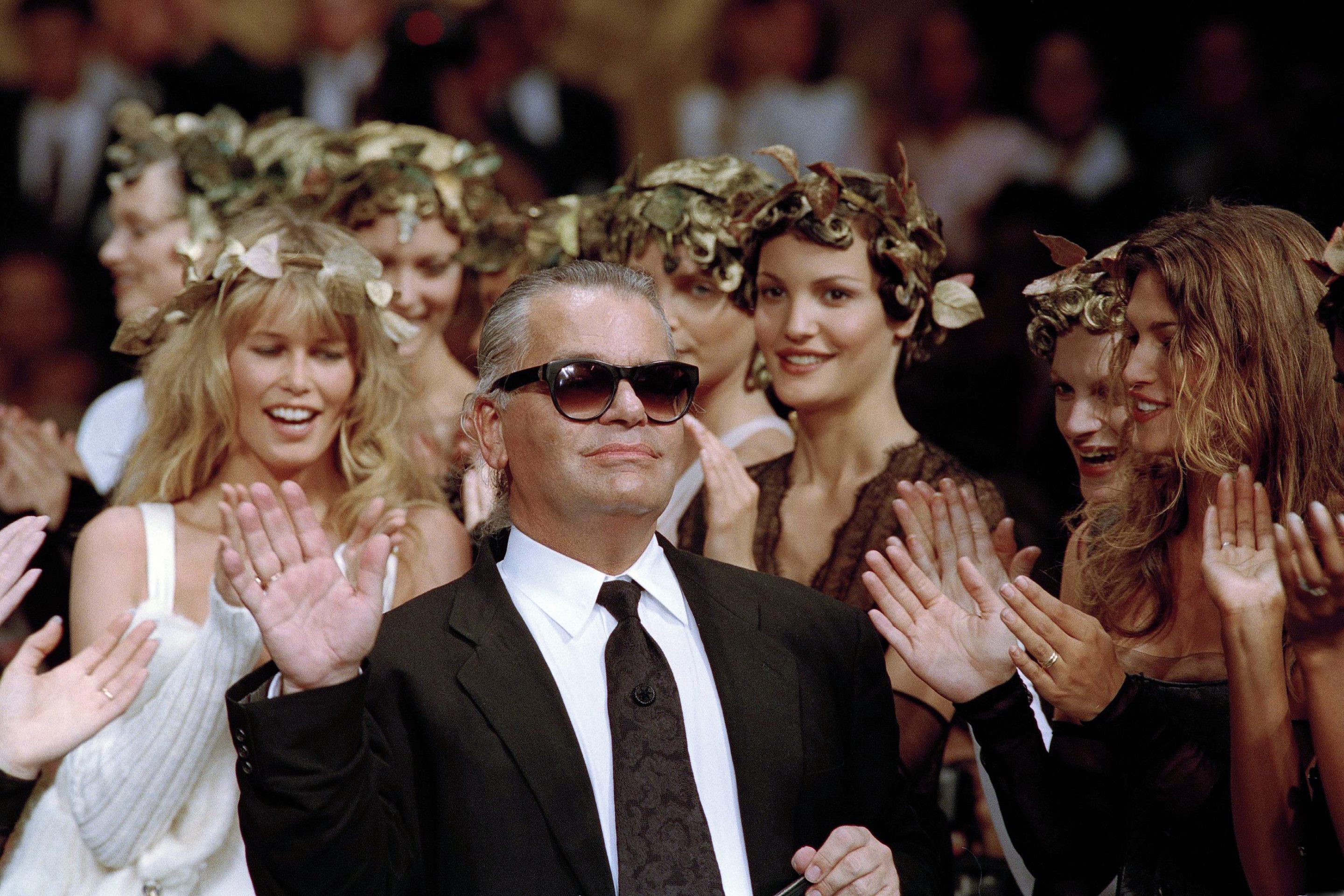 German fashion designer Karl Lagerfeld acknowledges the applause of his models at the end of the show he designed for the French fashion house Chanel, for the 1993-94 Fall-Winter haute couture collection in Paris, July 20, 1993.