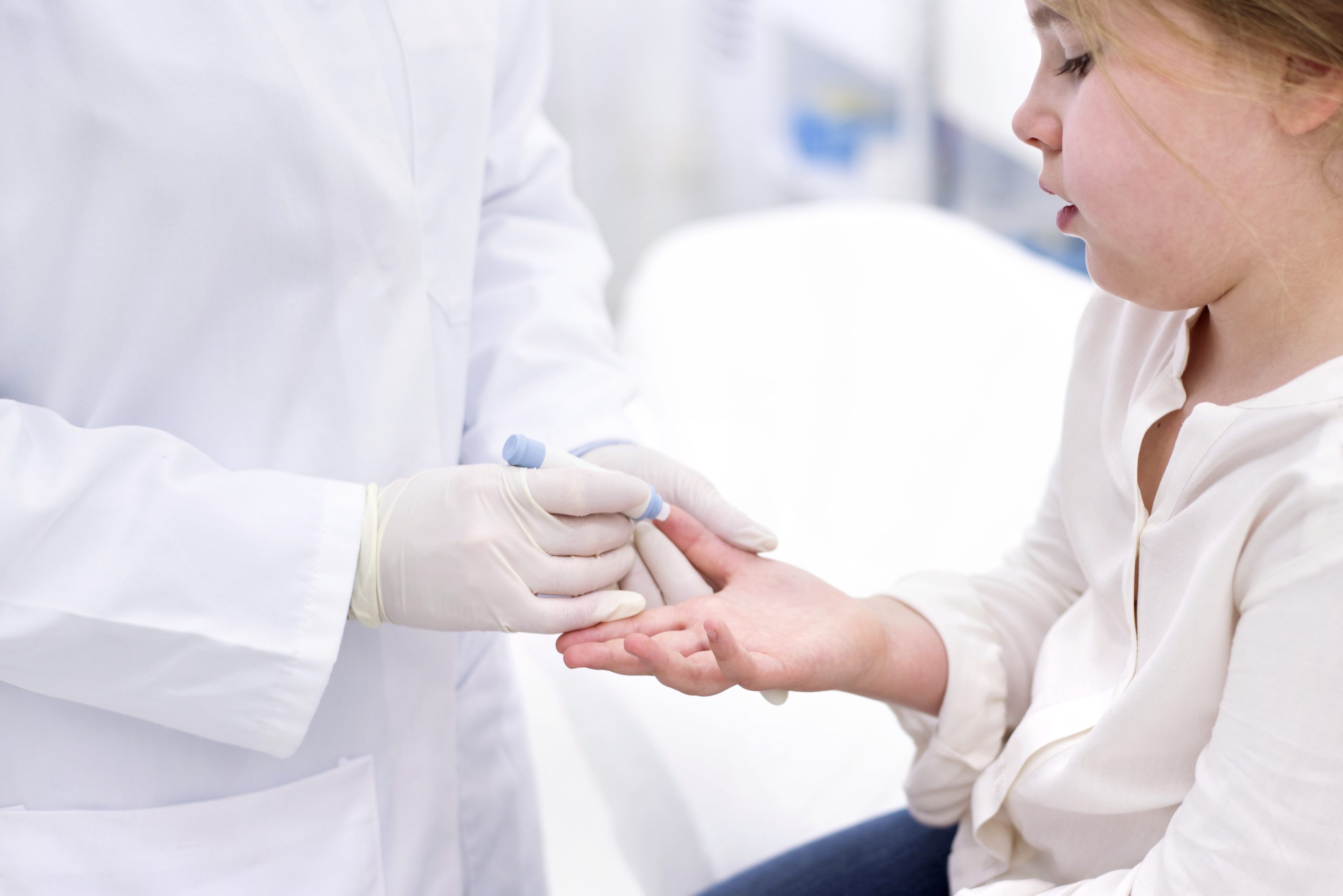 Girl having finger prick test