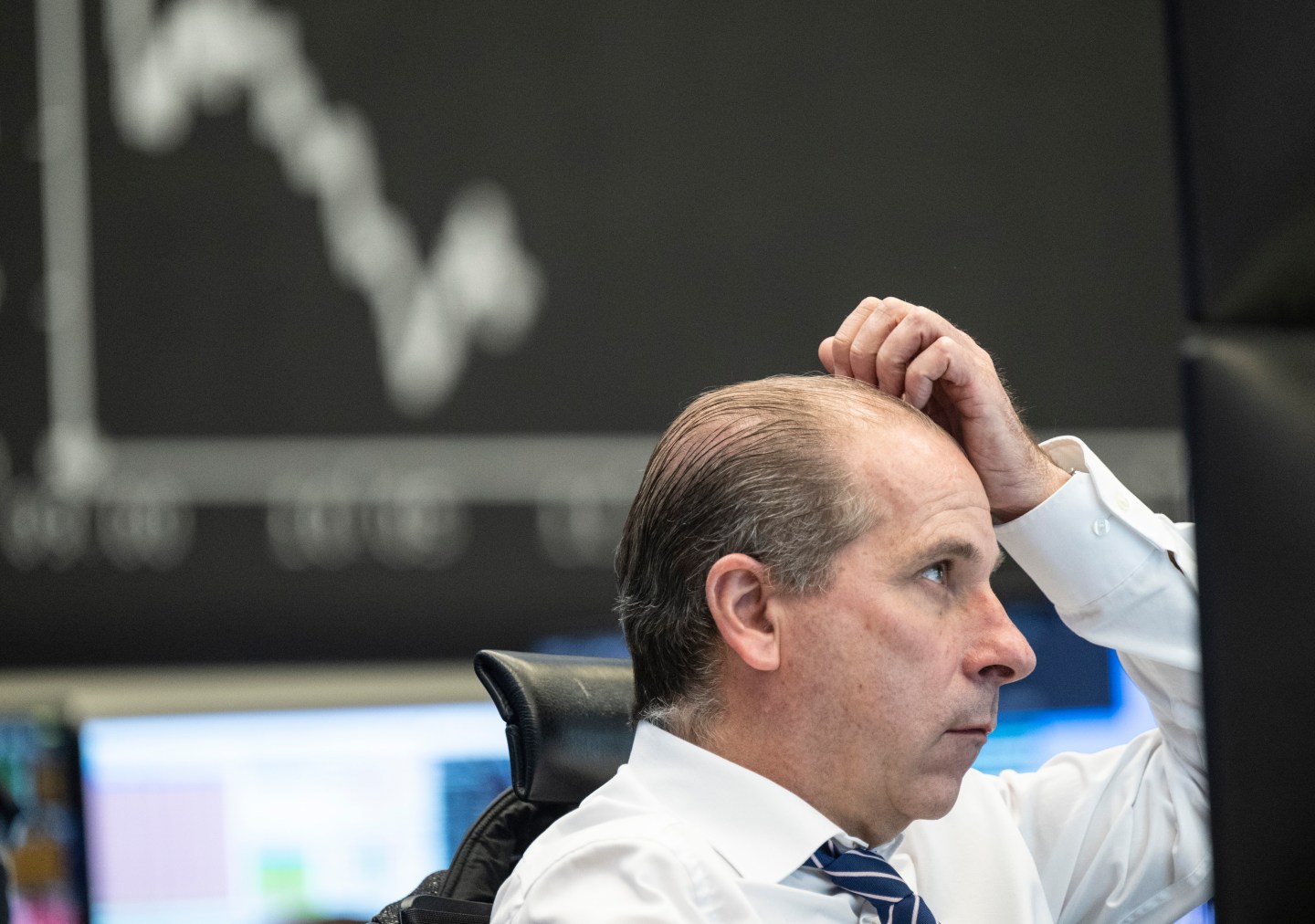 A man looks worriedly at a screen