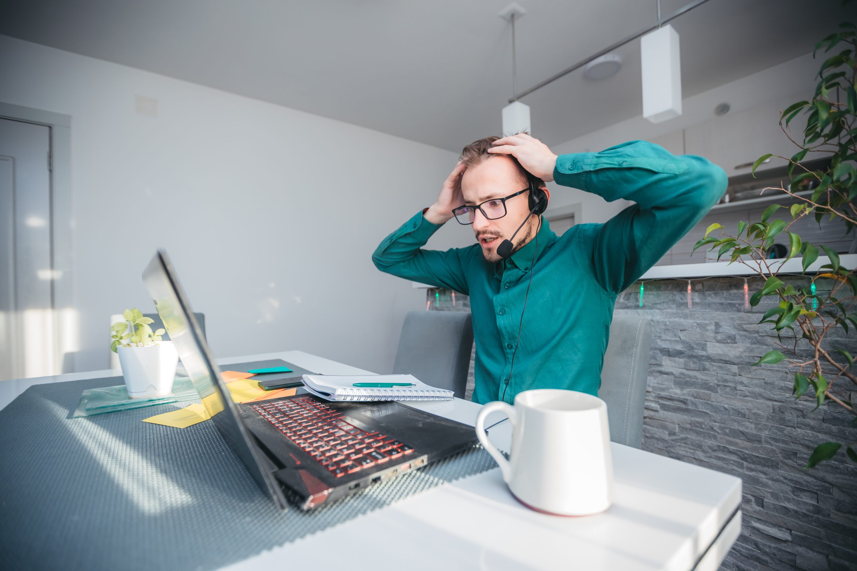 A man looking horrified with his computer.