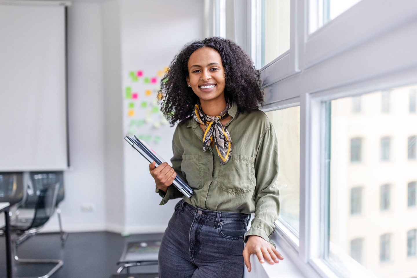 Smiling portrait of a beautiful woman standing in office