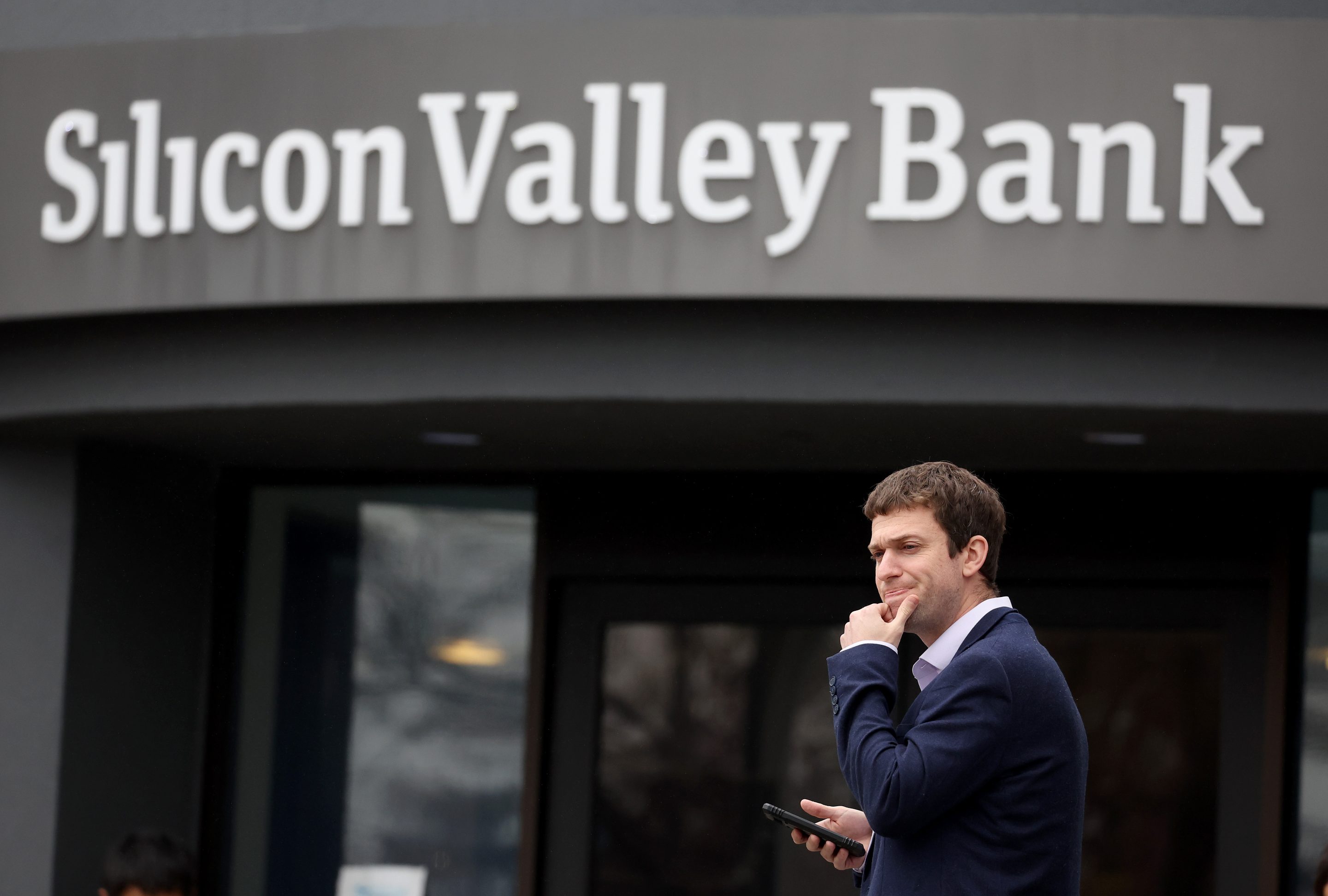 A customer outside the shuttered Silicon Valley Bank (SVB) headquarters on March 10, 2023, in Santa Clara, Calif.