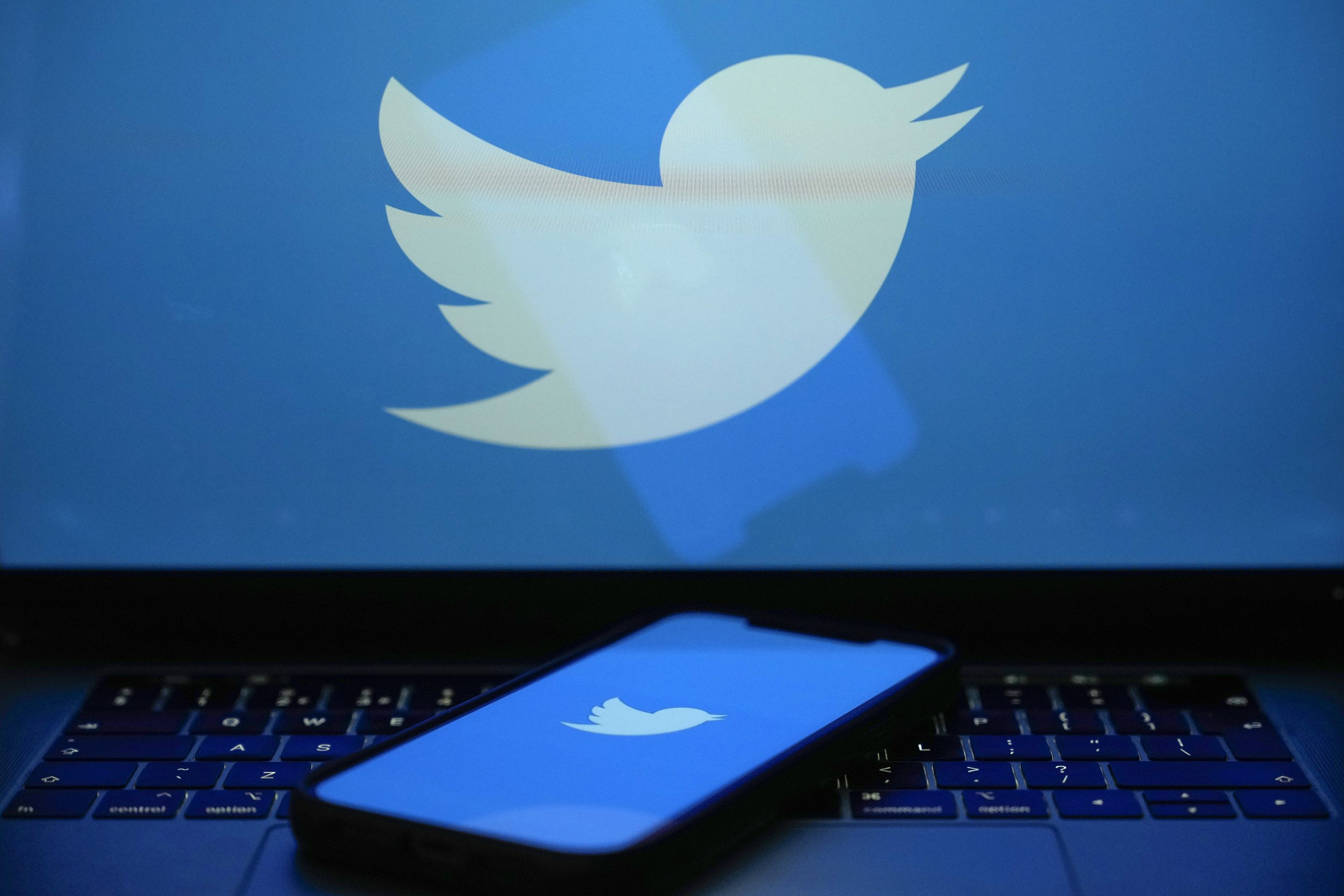 In this photo illustration the Twitter logo is seen on a computer screen and mobile cellphone on April 21, 2023 in Knutsford, United Kingdom.