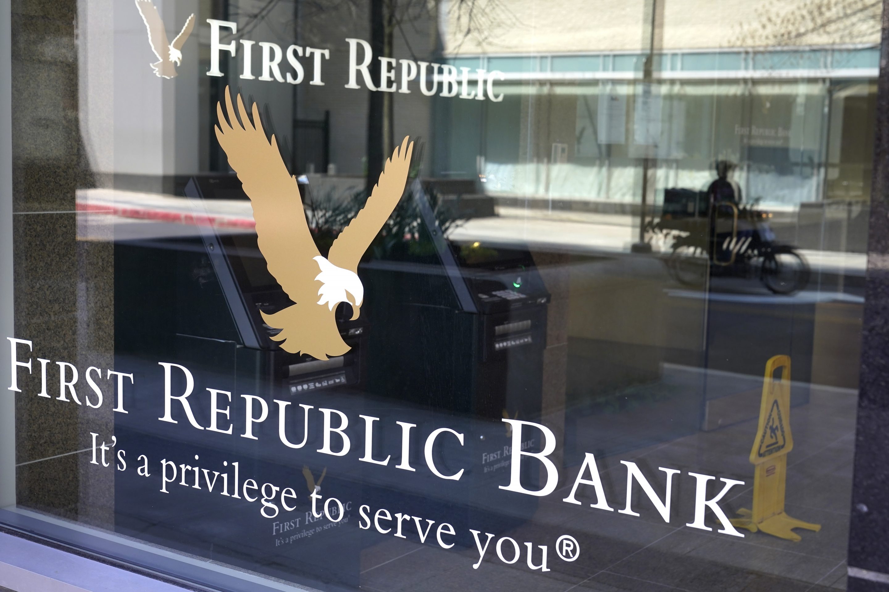 First Republic Bank signs and logos are attached to a window at a branch location, Wednesday, April 26, 2023, in Boston.
