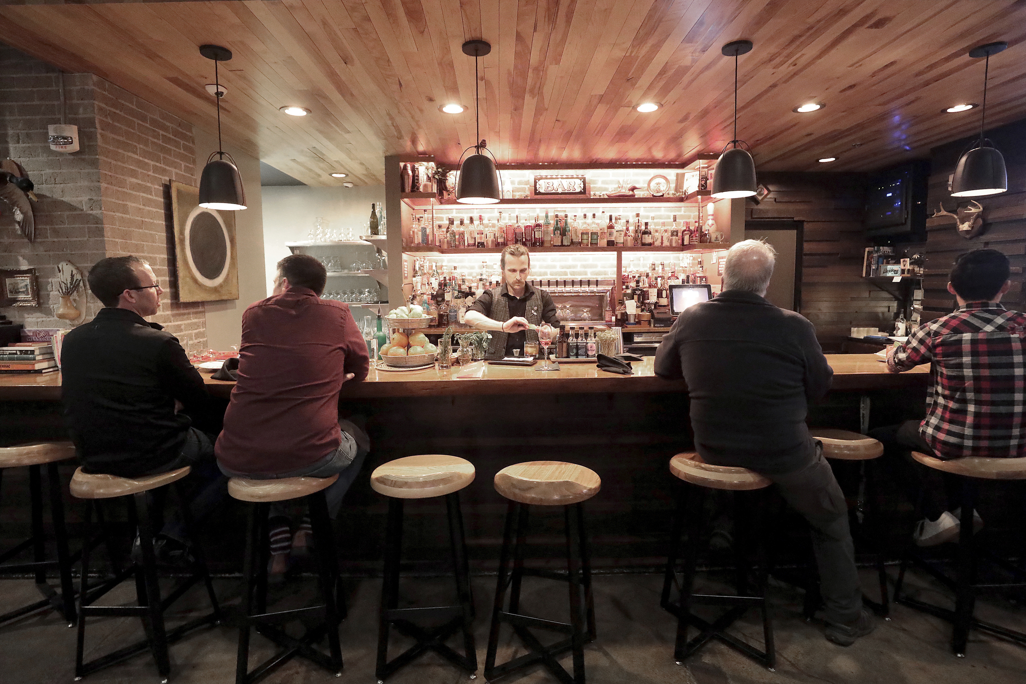 Patrons sit in a hotel bar in Eau Claire, Wis., May 1, 2019.