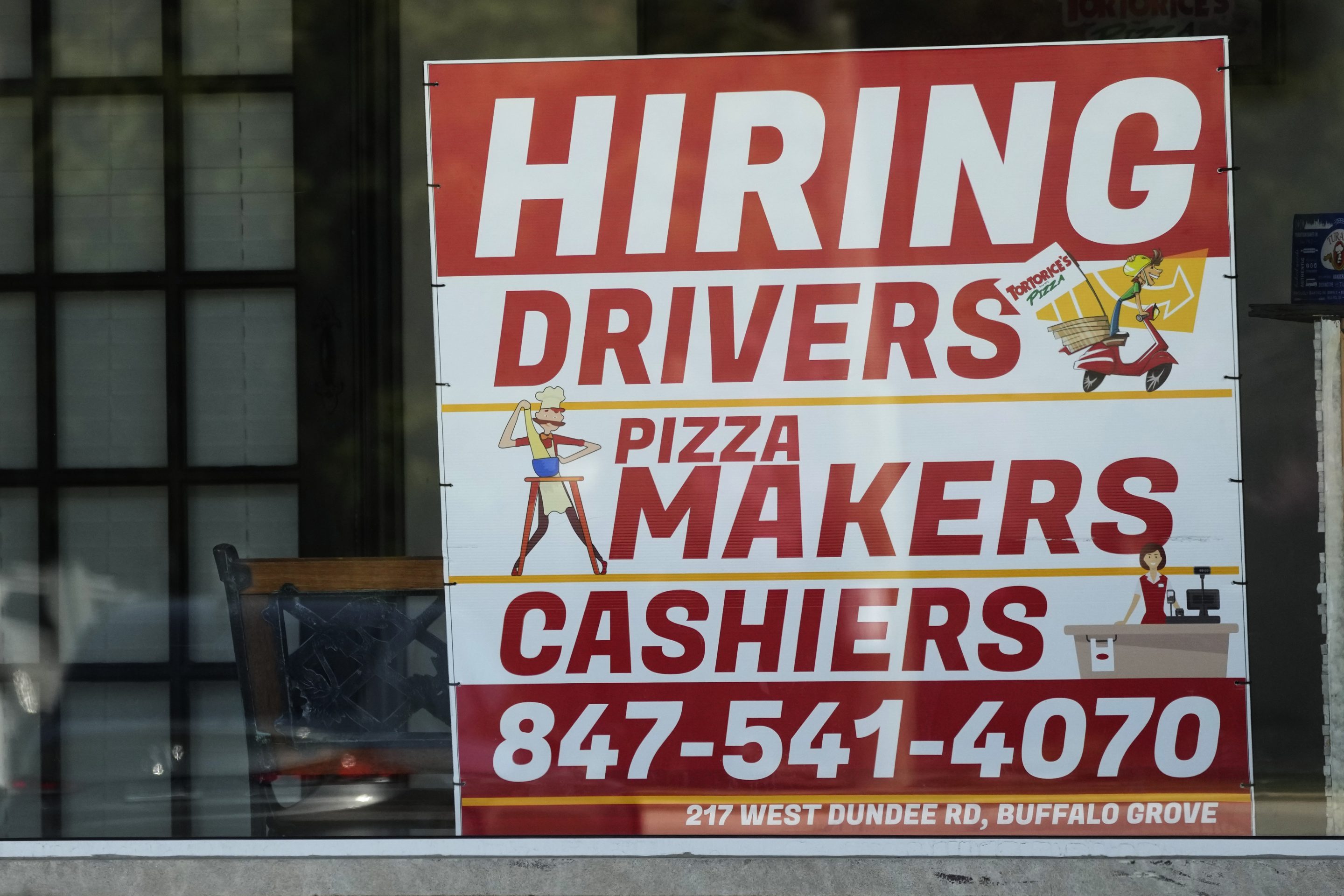 A hiring sign is displayed at a restaurant in Buffalo Grove, Ill., Wednesday, May 10, 2023.