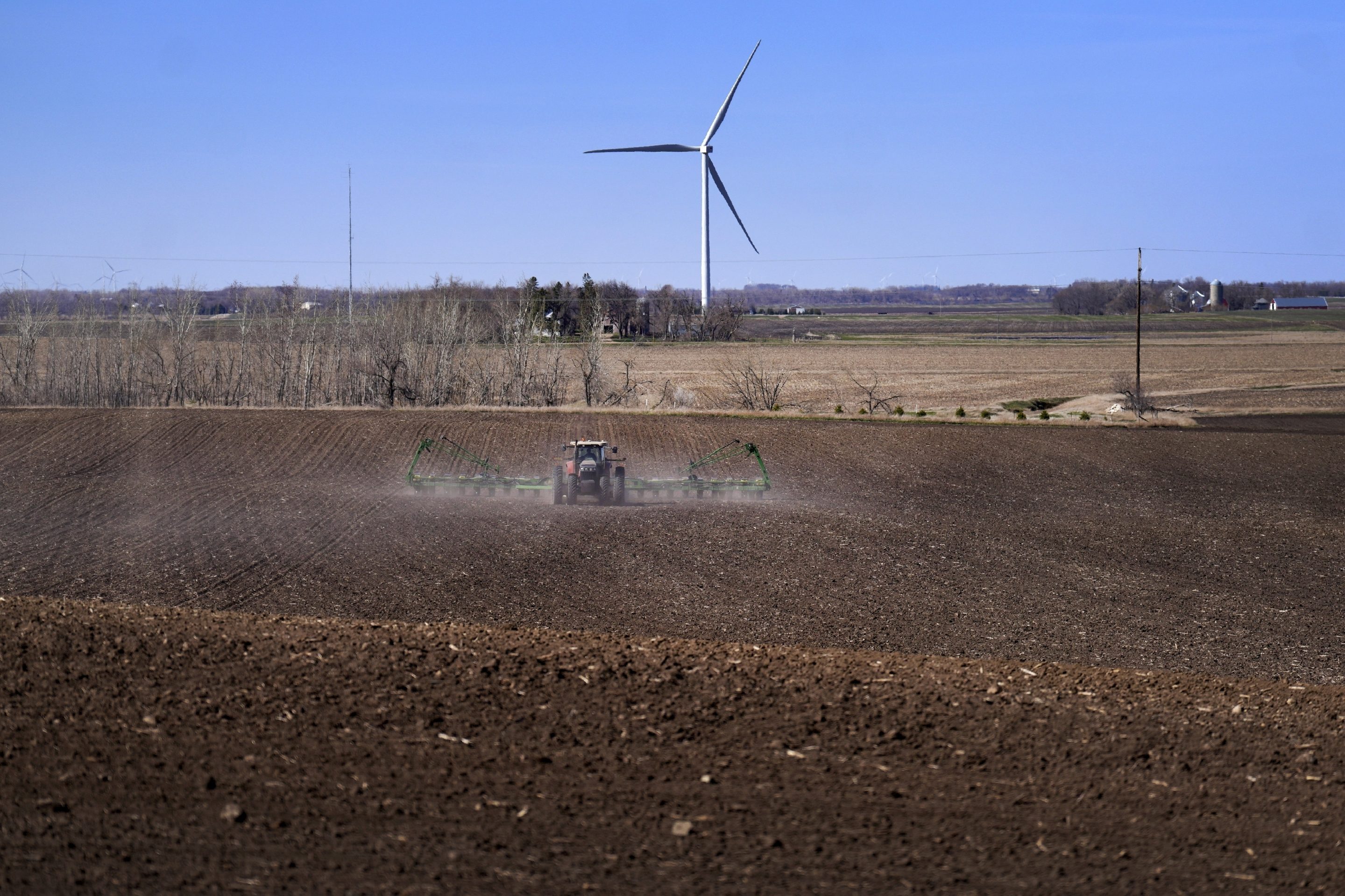 Corn is planted with a view of wind turbines on April 2, 2023, in Lake Benton, Minn. 