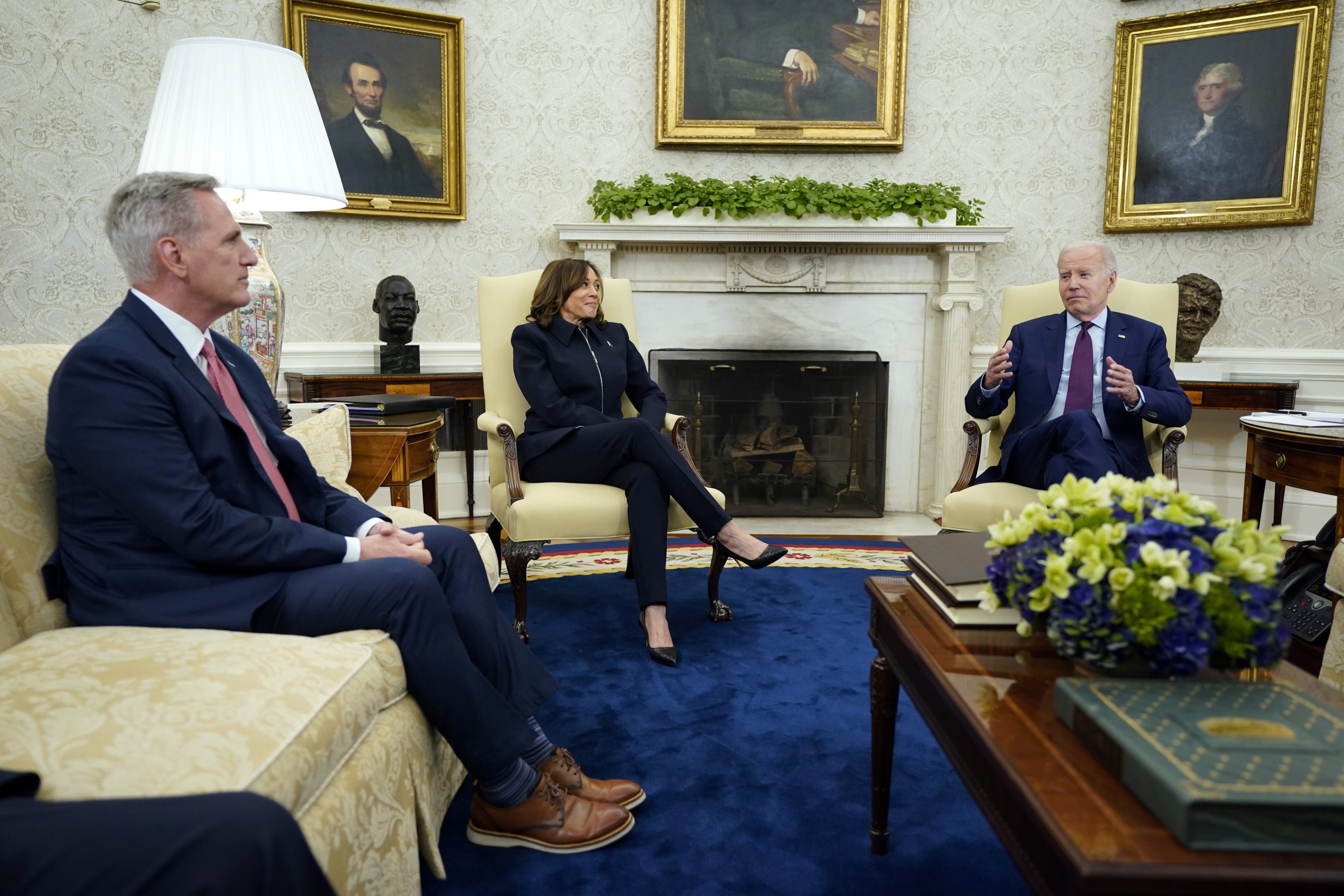 Speaker of the House Kevin McCarthy of Calif., left, and Vice President Kamala Harris listen as President Joe Biden speaks during a meeting with Congressional leaders in the Oval Office of the White House, on May 16, 2023, in Washington.