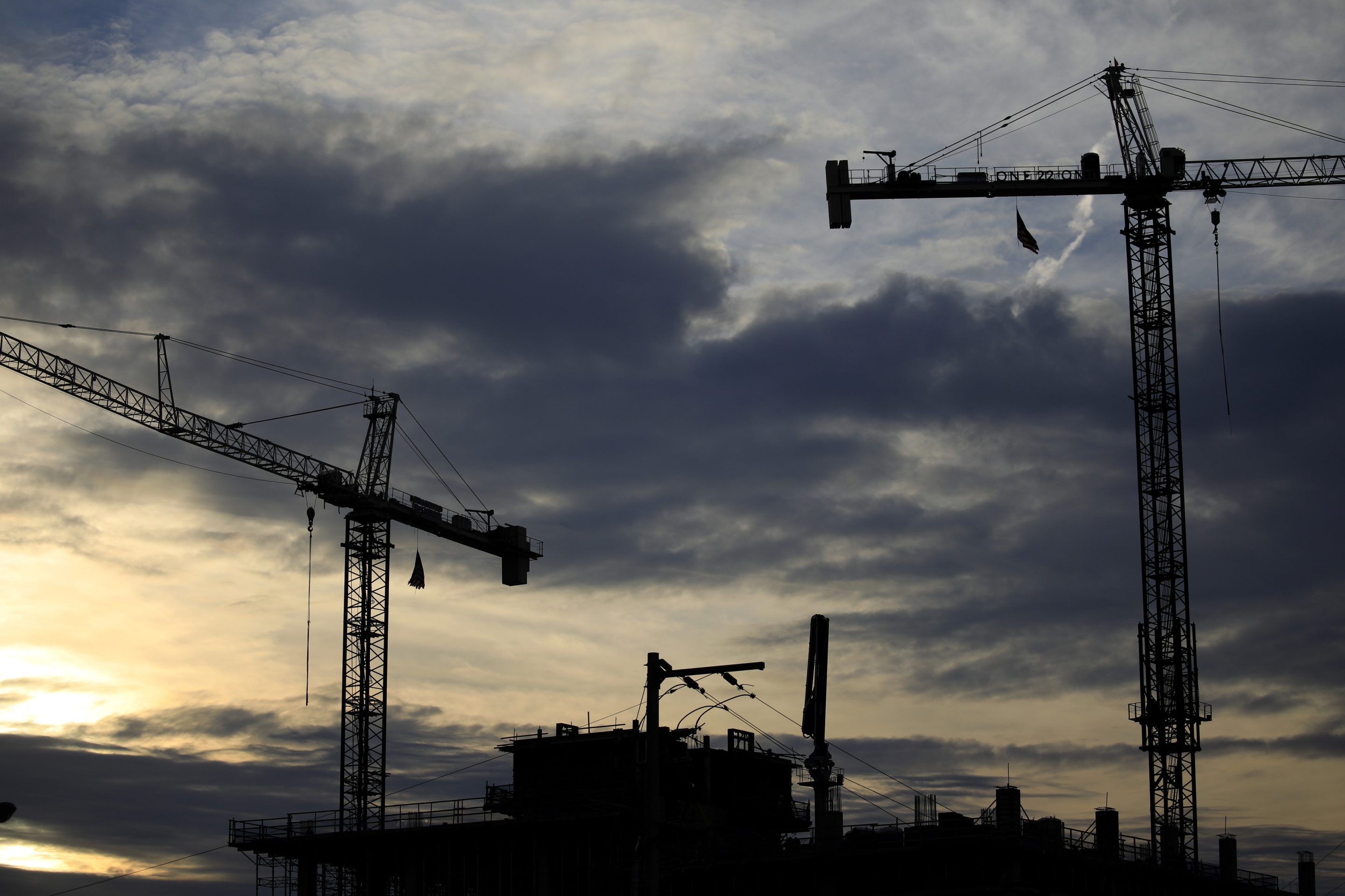 Construction cranes are silhouetted above high-rise condominium buildings in downtown Nashville, Tennessee on May 17.