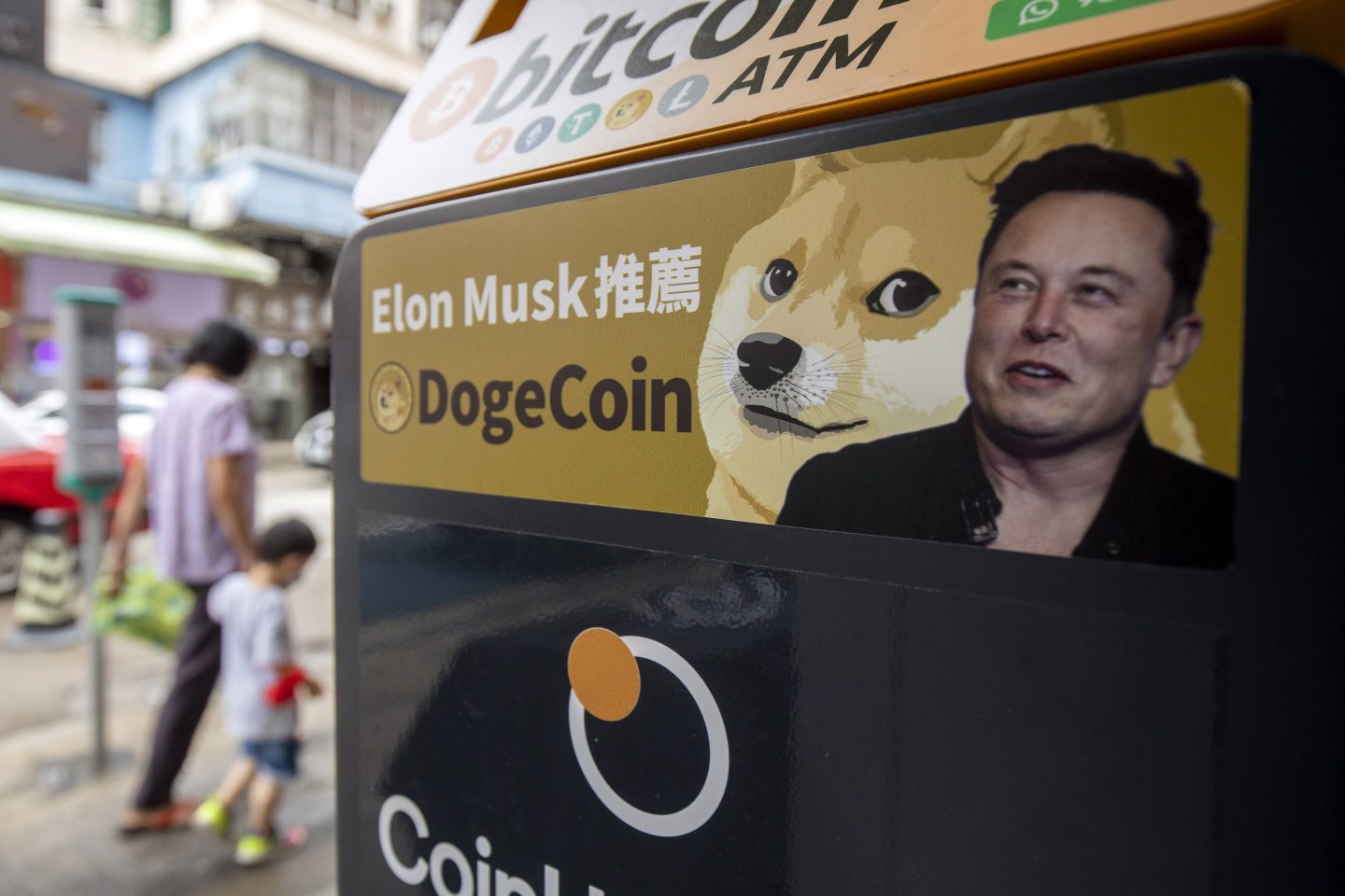 A sticker advertising Dogecoin on a cryptocurrency ATM.