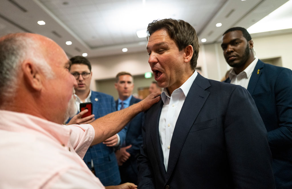 Florida Gov. Ron DeSantis speaks with attendees during an Iowa GOP reception on May 13, 2023, in Cedar Rapids.