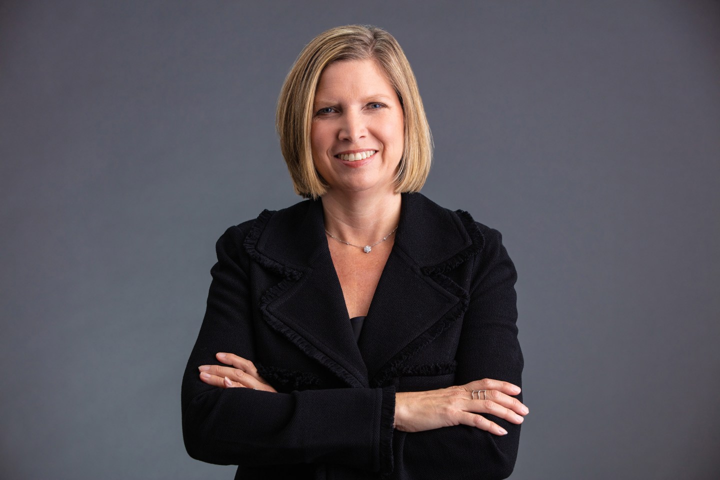 woman wearing a suit jacket and smiling