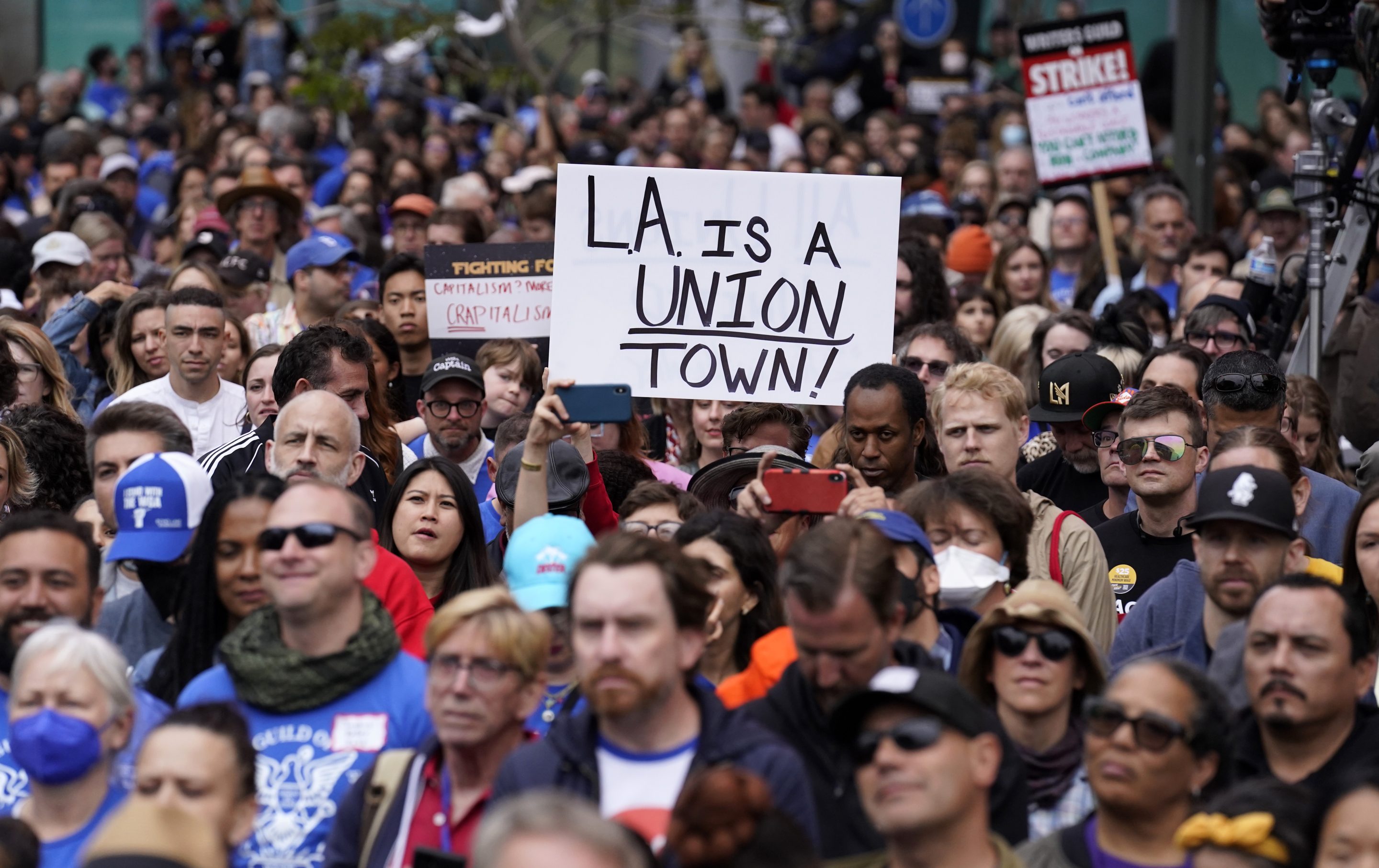 Crowd members listen to a speaker during the "Unions Strike Back" rally, on May 26, 2023, near Crypto.com Arena in Los Angeles. 